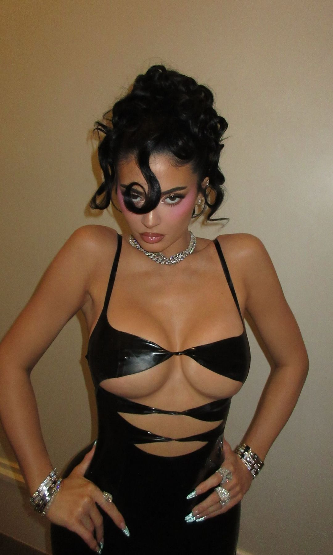 Kylie Jenner poses in a cut-out latex mini dress