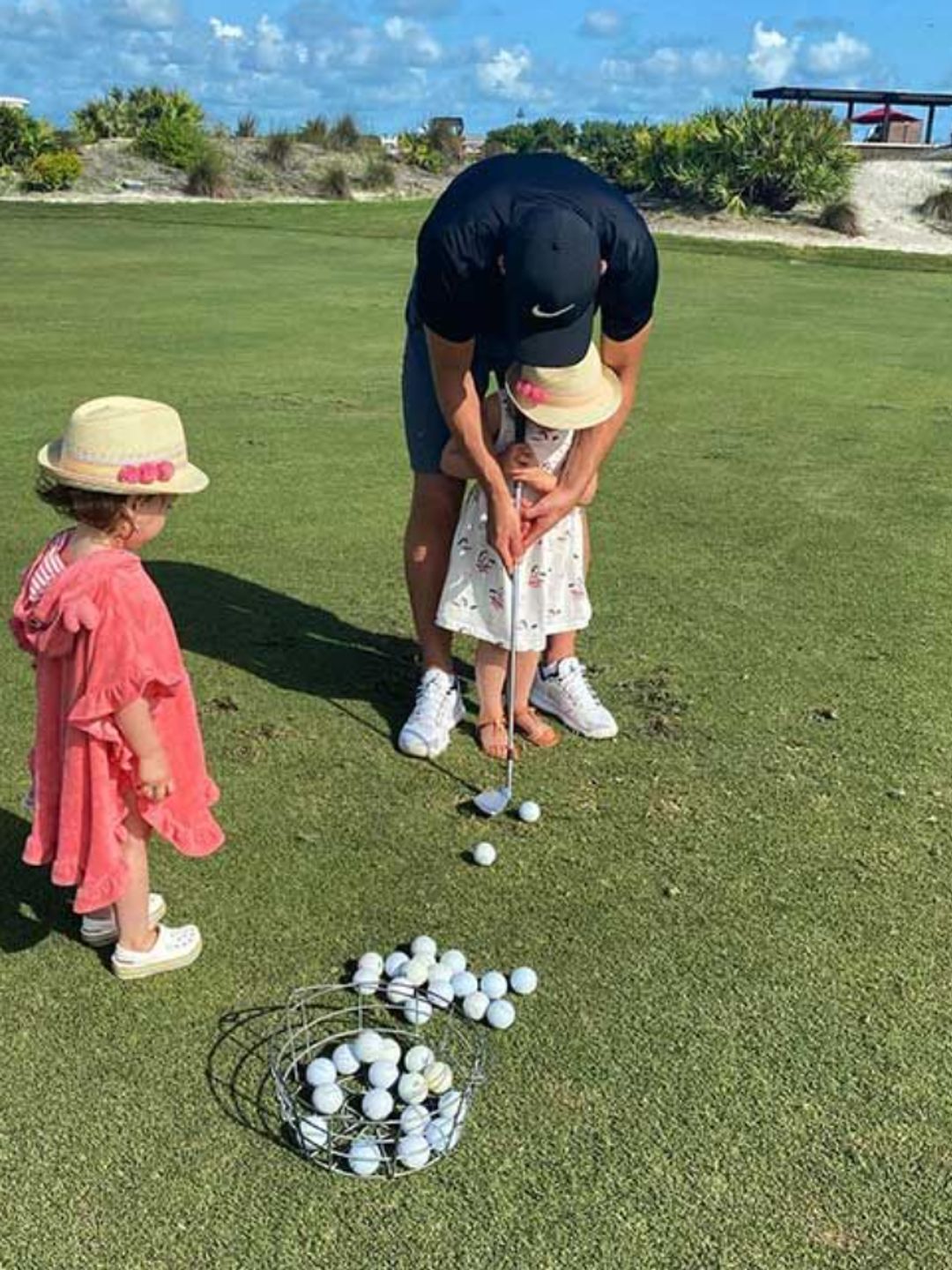 Harry Kane playing golf with two yougn girls