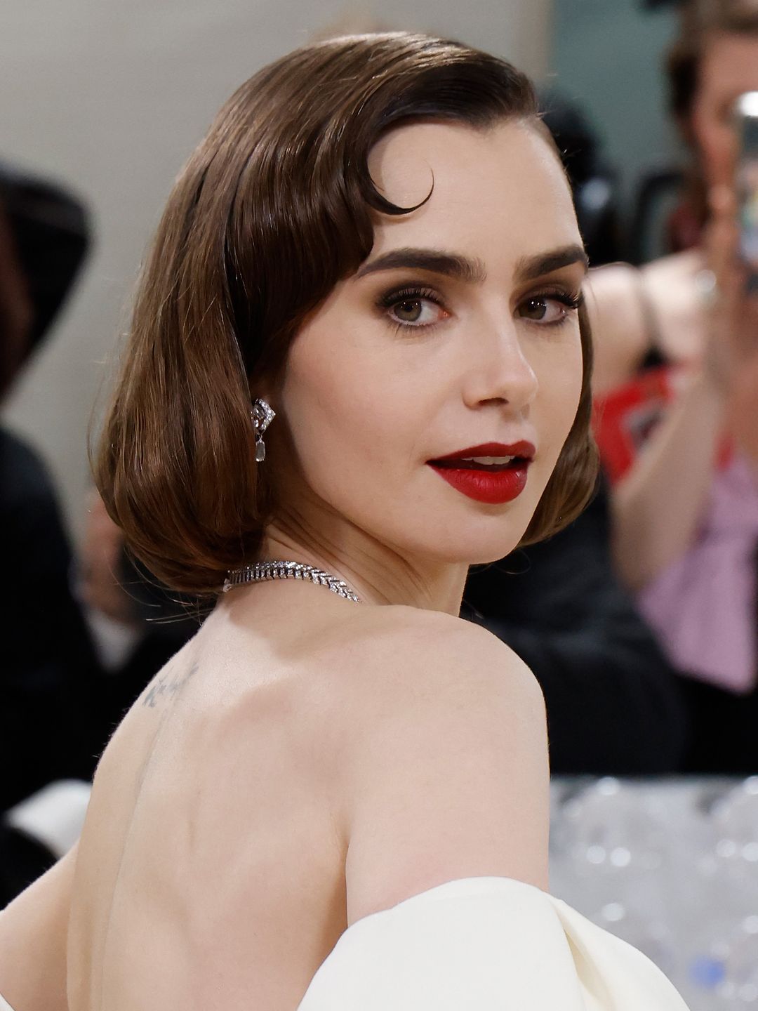 Lily Collins with a soft bob and red lipstick at the 2023 Met Gala 
