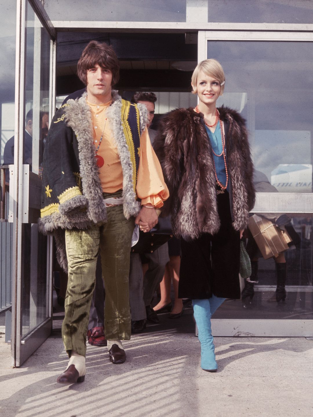 Twiggy stuns in a combination of fur textures and vibrant colors. The bohemian layers and flared trousers capture the eclectic, free-spirited style that defined late-1960s fashion. .