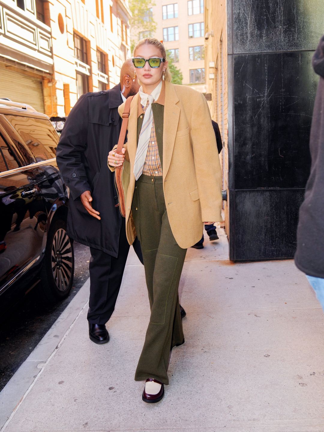 Gigi Hadid wearing a tie and trousers 