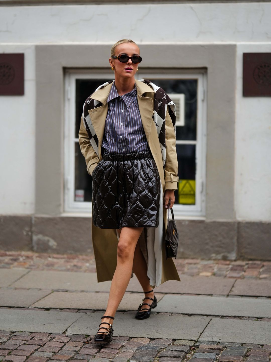 Woman wearing a trench coat with quilted skirt 