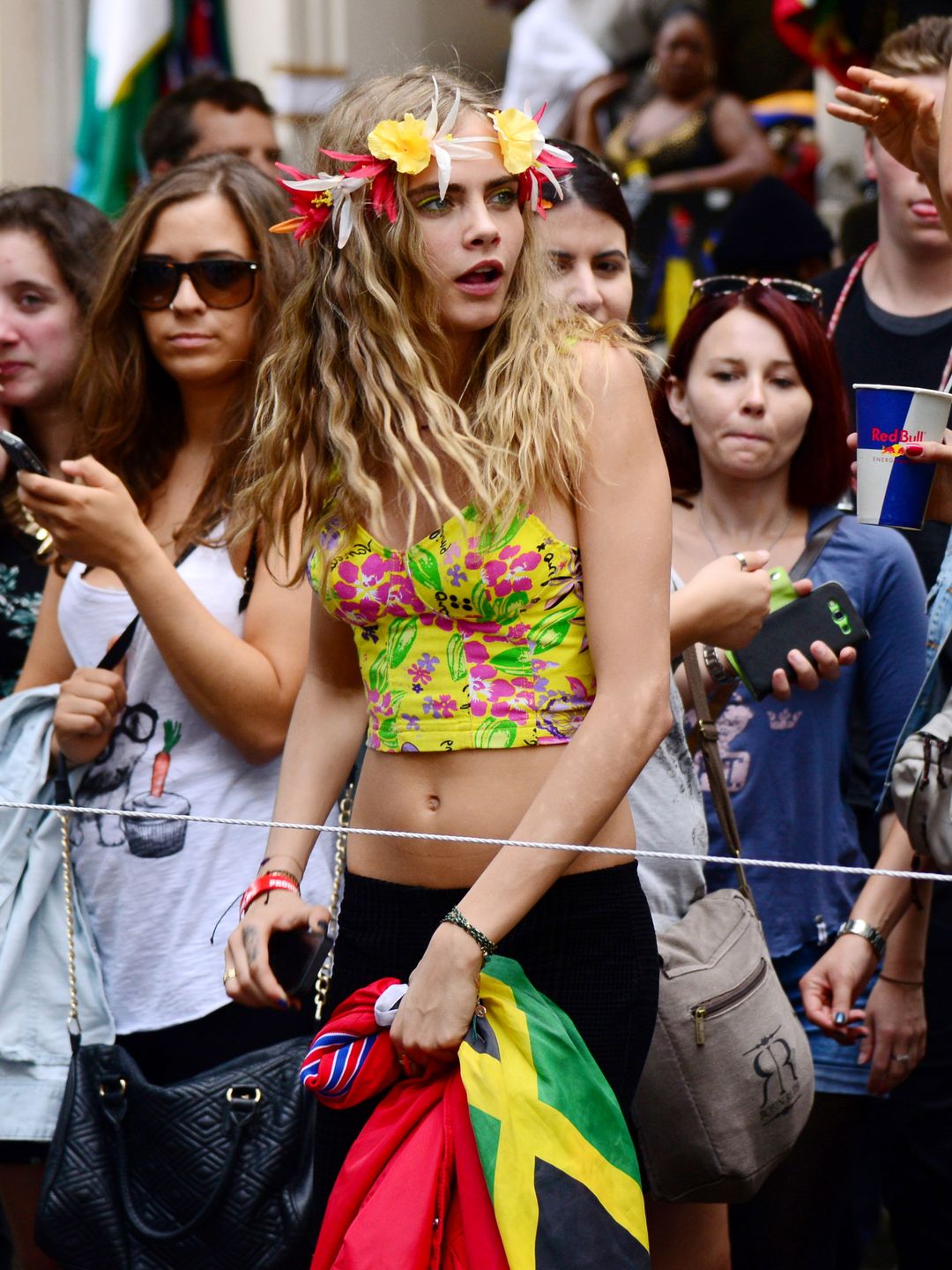 Cara Delevingne wearing a vibrant floral crop top at Notting Hill in 2013 