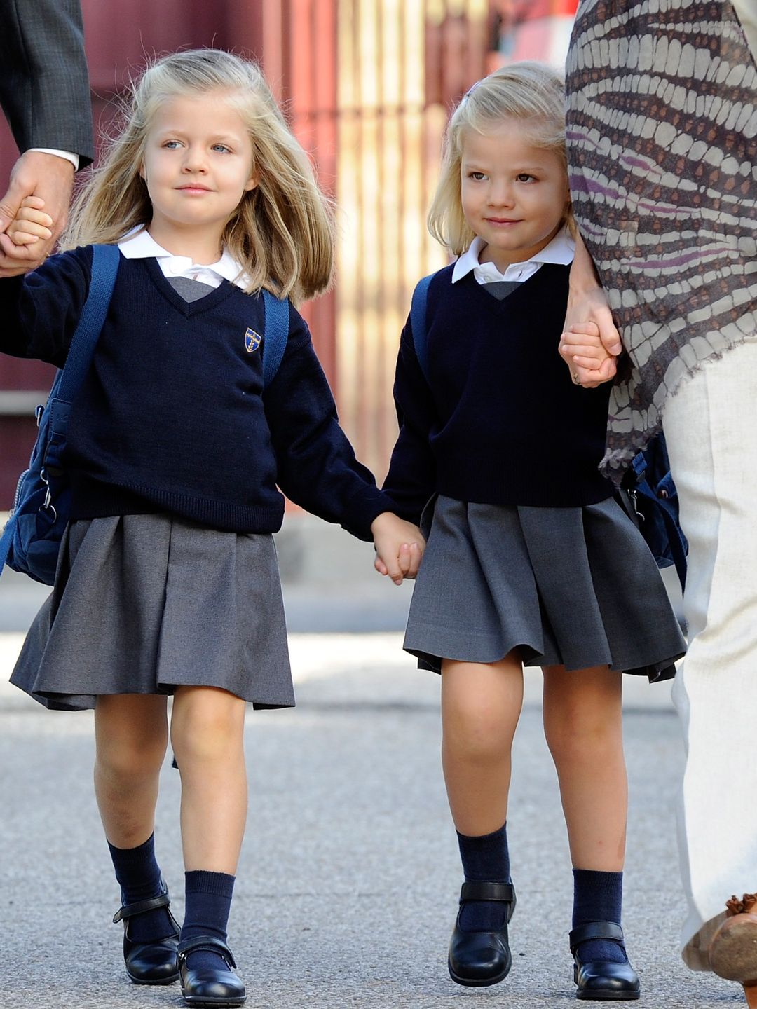 A young Princess Leonor holding Infanta Sofia's hand