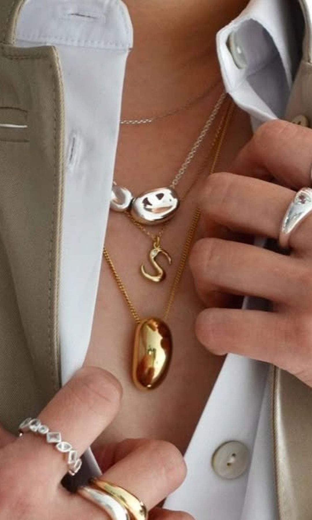 A photo of a woman wearing a necklace stack