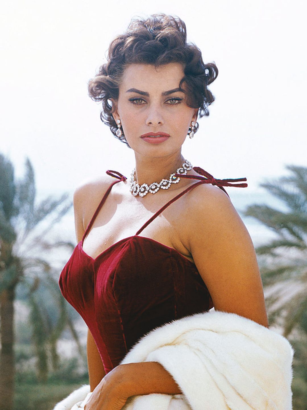 Italian actress Sophia Loren, circa 1965. She is wearing a red strappy dress. 