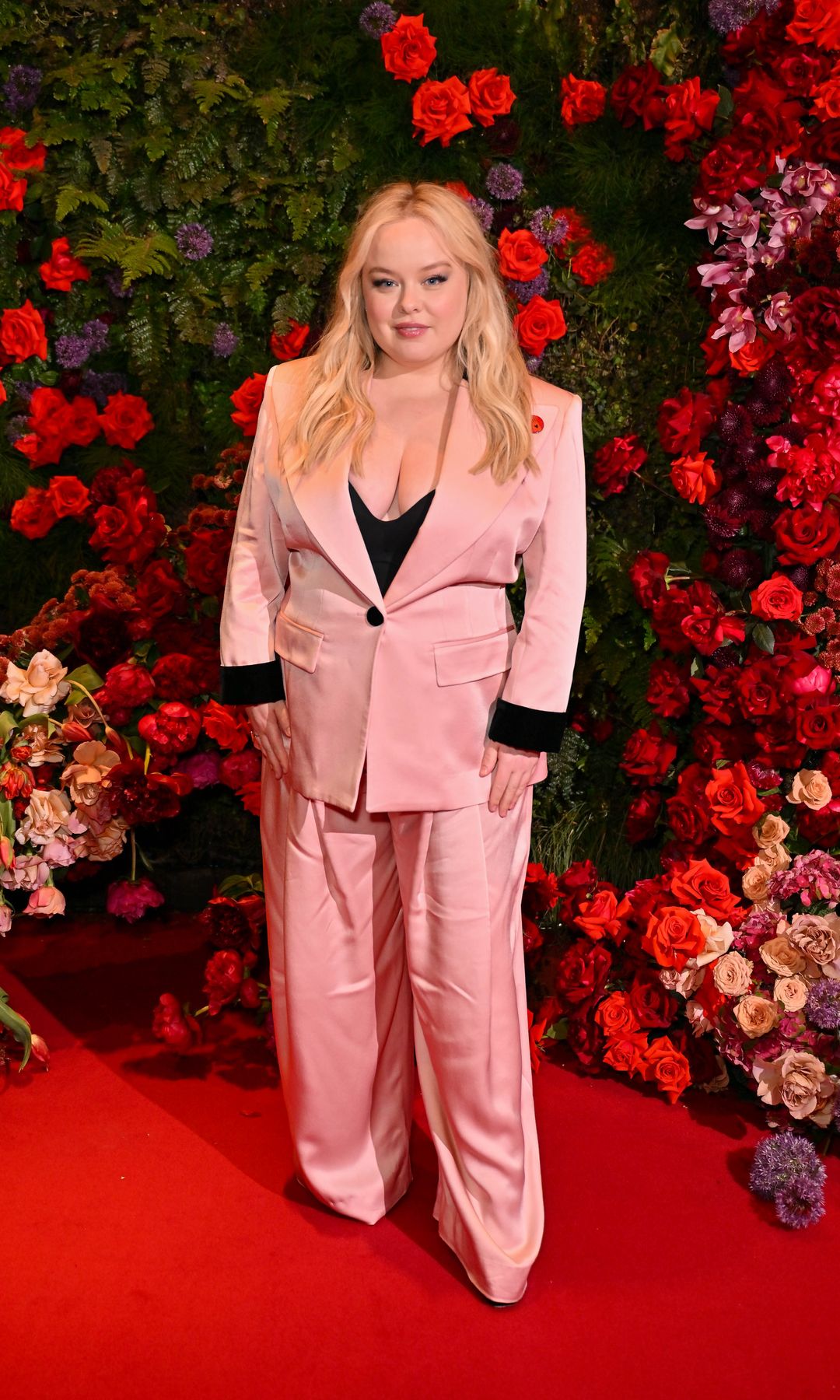 Nicola Coughlan attends an event hosted by British Vogue and Netflix to celebrate the BAFTA Television Awards at Dovetale at 1 Hotel on May 8, 2025 in London, England wearing a pink suit