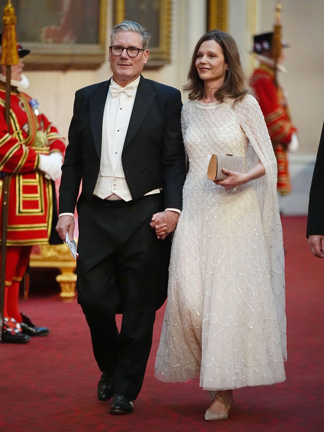 Keir Starmer and wife Victoria walking through Buckingham Palace