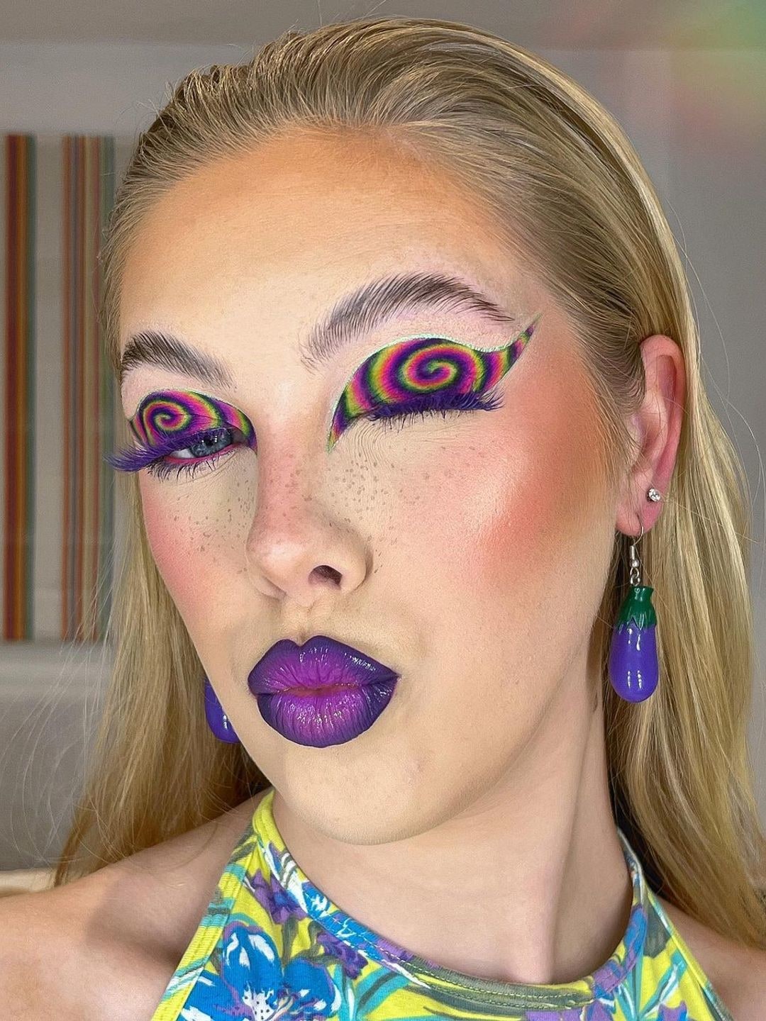 Woman with retro swirl purple makeup 
