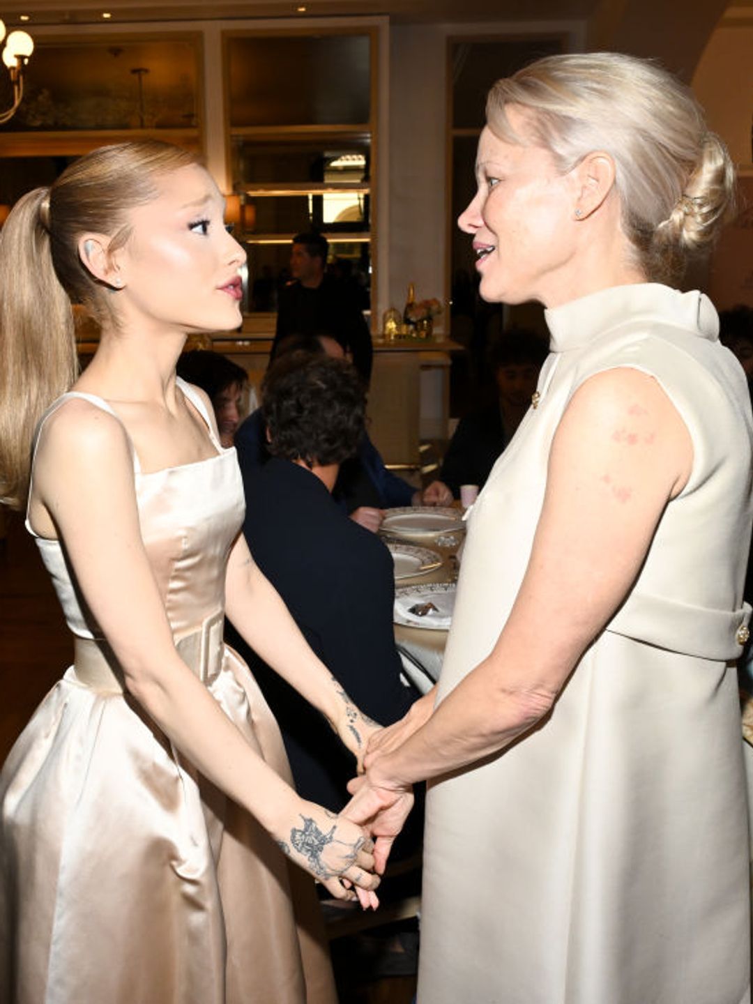 Ariana Grande chats with Pamela Anderson at the Golden Globes First-Time Nominee Luncheon 