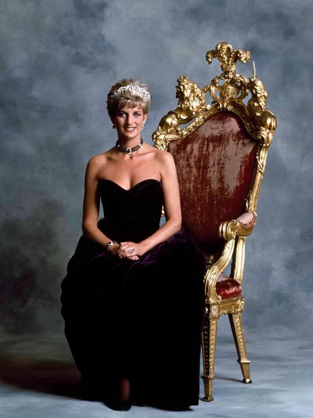 Princess Diana posing for a portrait in the velvet purple gown
