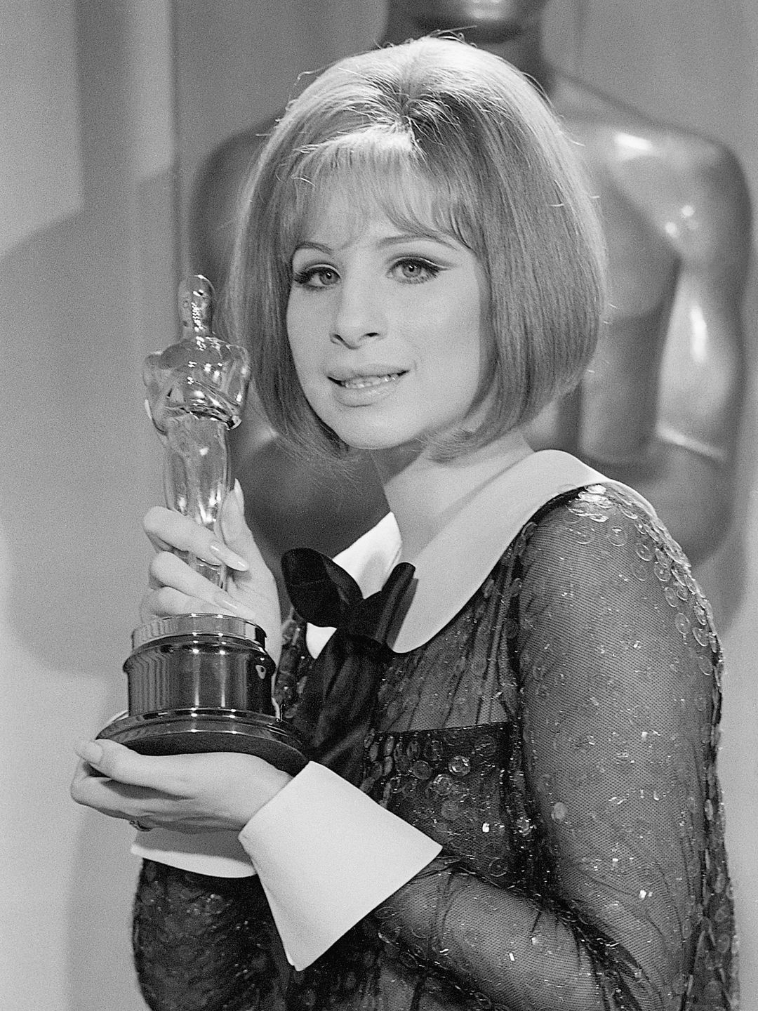 (Original Caption) 4/14/69-Los Angeles, CA- Barbra Streisand holds her "Oscar" after she was named co-winner of the Best Actress Award in the 41st Annual Academy Awards. Streisand and Katharine Hepburn made Academy history with the dual award.