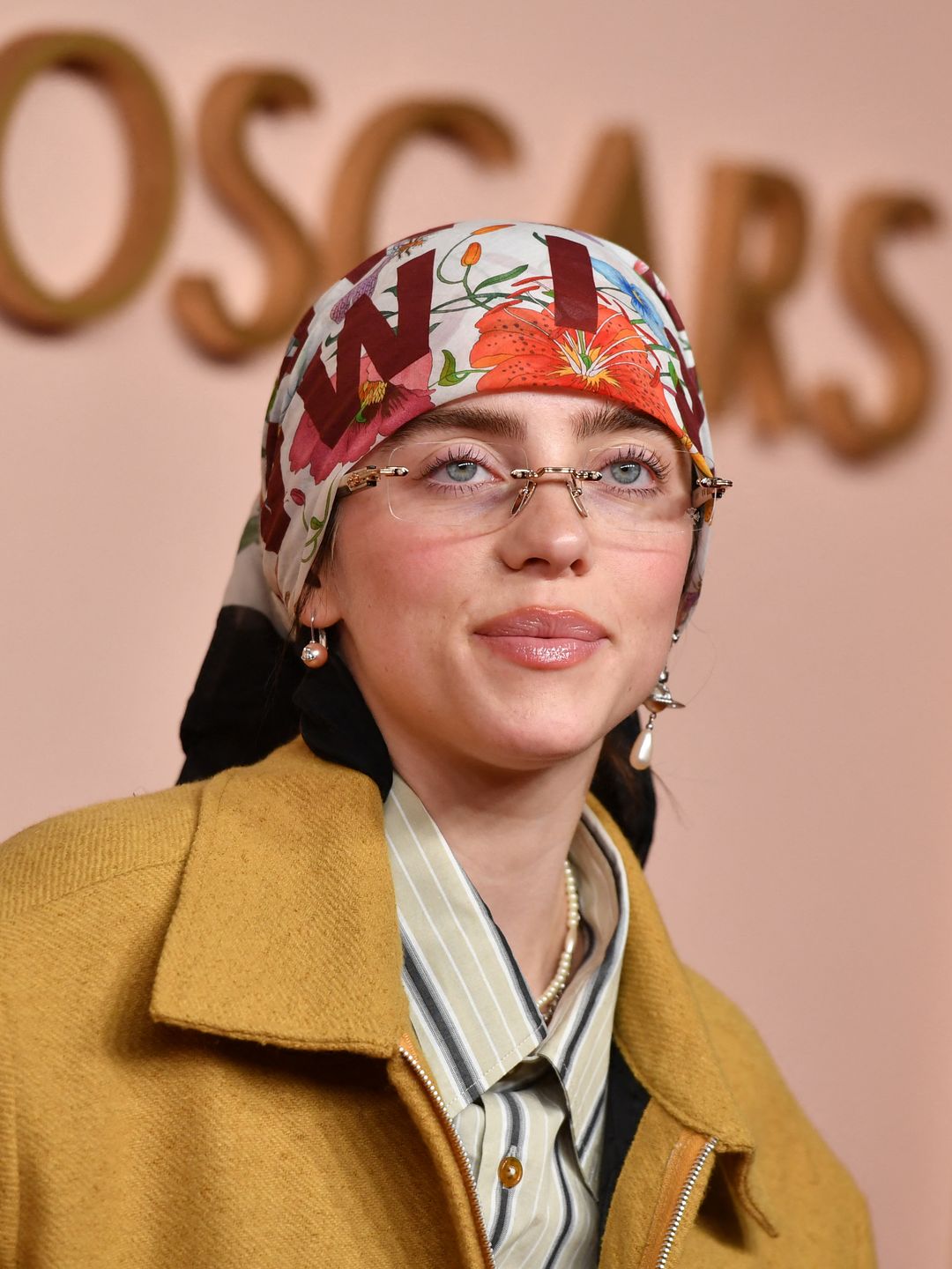 Billie Eilish wearing a headscarf and rimless glasses at the Oscars Luncheon