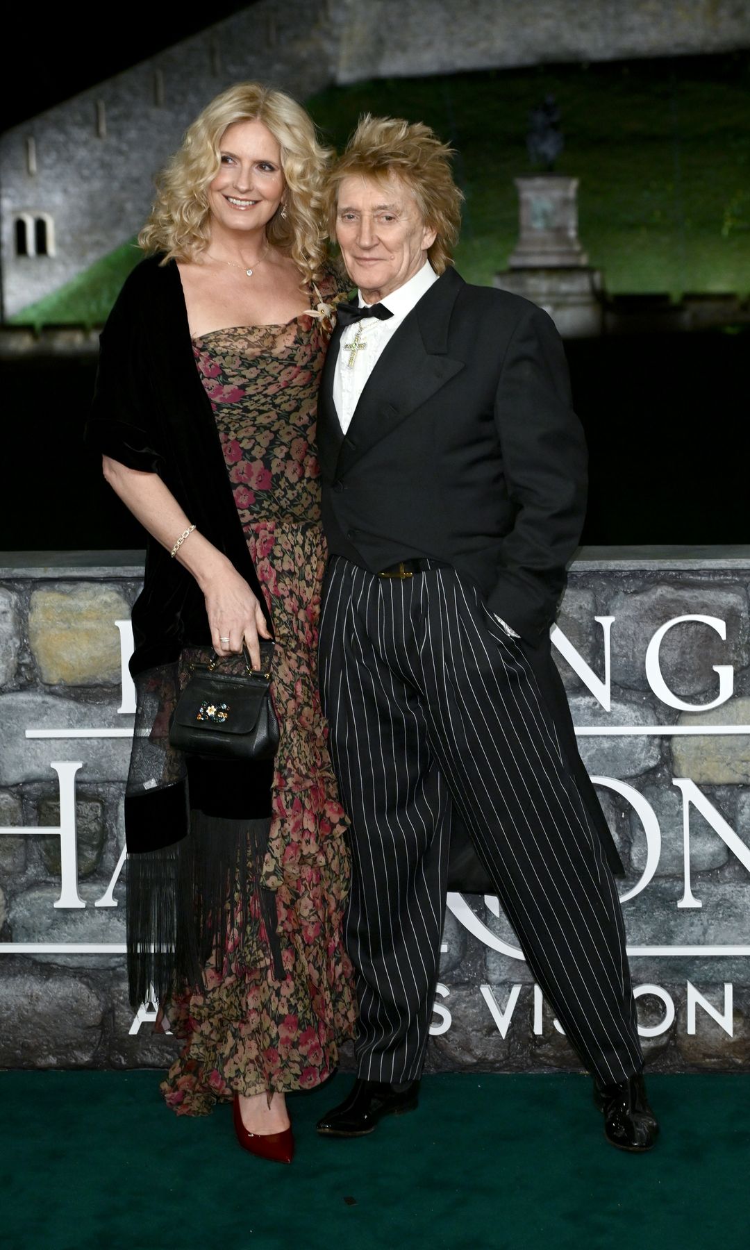 Penny Lancaster standing with Rod Stewart outside Windsor Castle
