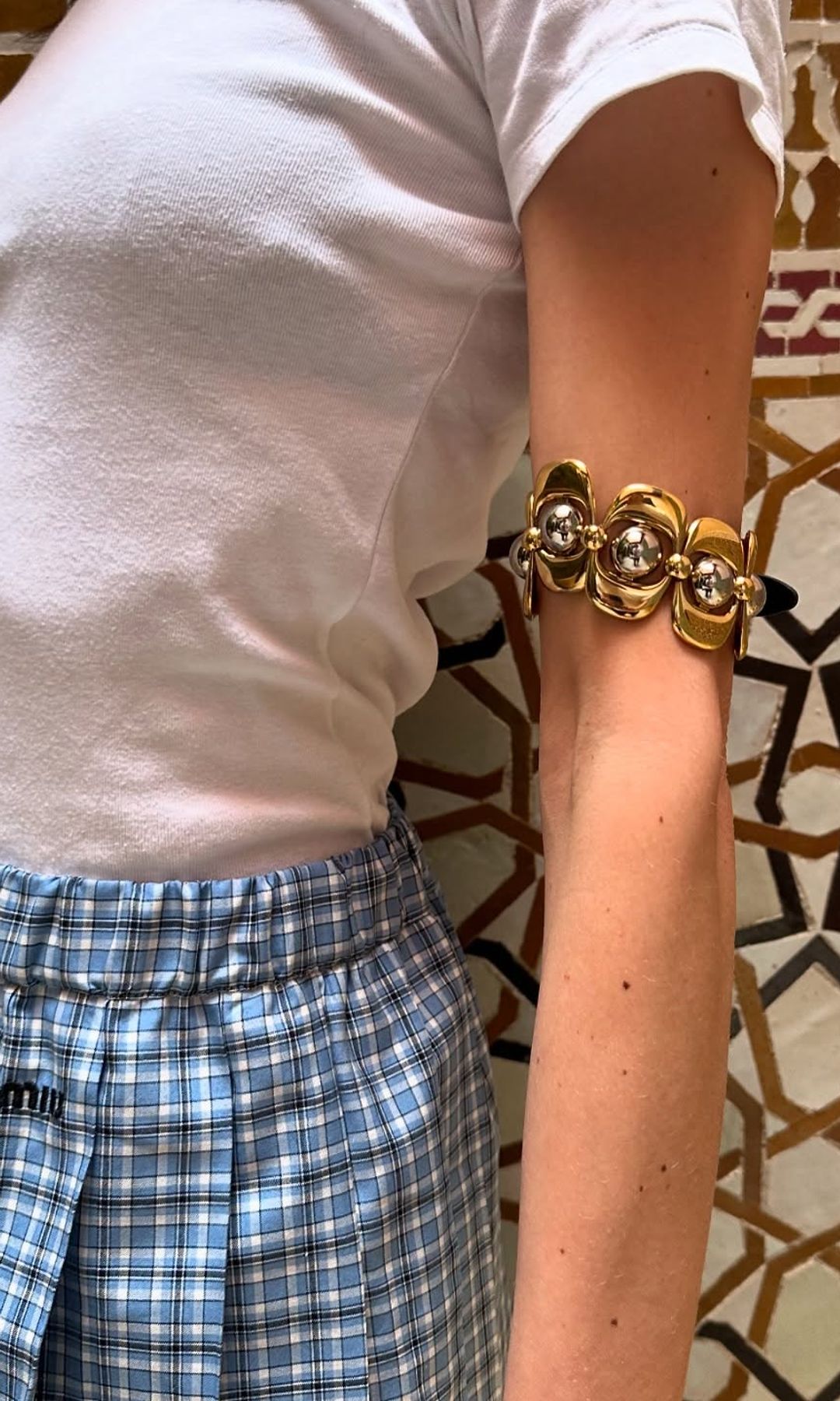 Alexa Chung shares a close up image of her Miu Miu arm cuff