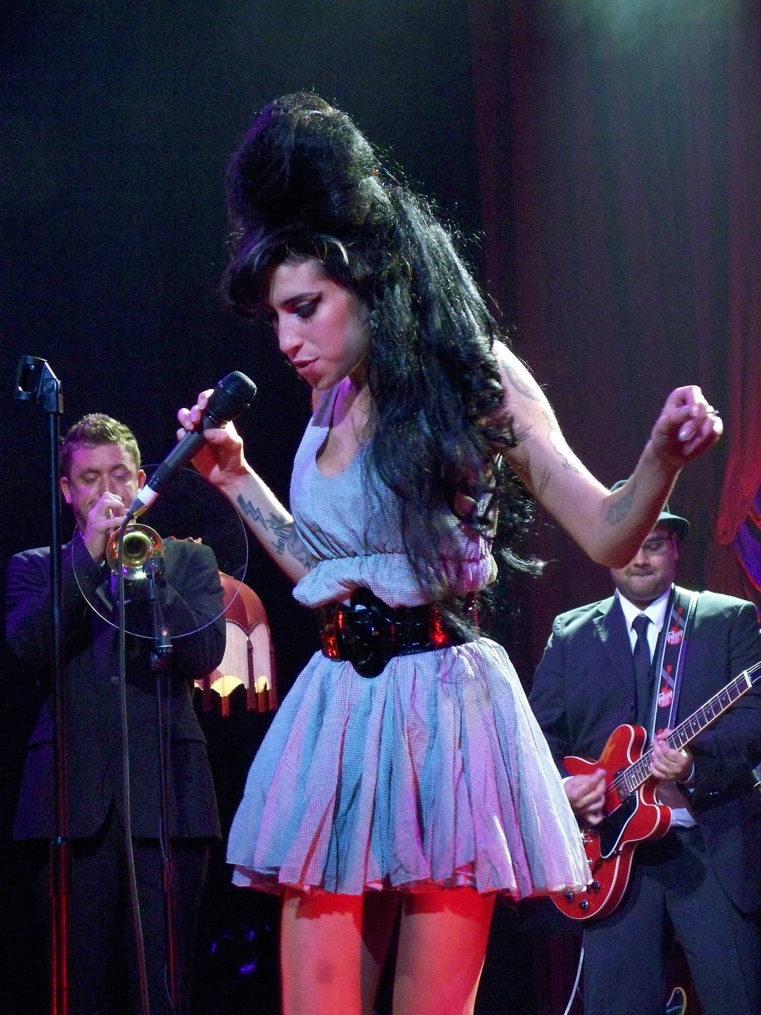 Amy Winehouse performing at Shepherd's Bush Empire in 2007 wearing a baby blue dress with a black belt
