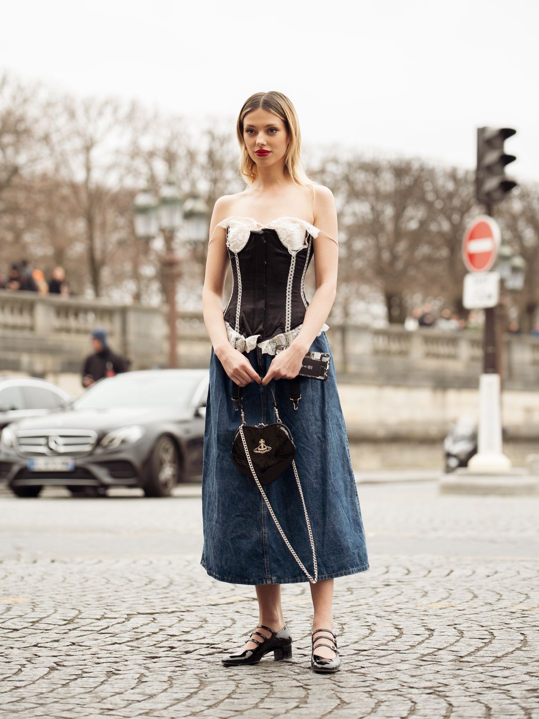 PARIS, FRANCE - MARCH 04: Danielle Marcan seen wearing a complete Vivienne Westwood look with a denim shoulder free corsage, a jeans skirt, black ballet flats and a black heart bag 
 outside the Vivienne Westwood show during Paris Fashion Week - Womenswear Fall Winter 2023 2024 on March 04, 2023 in Paris, France. (Photo by Raimonda Kulikauskiene/Getty Images)