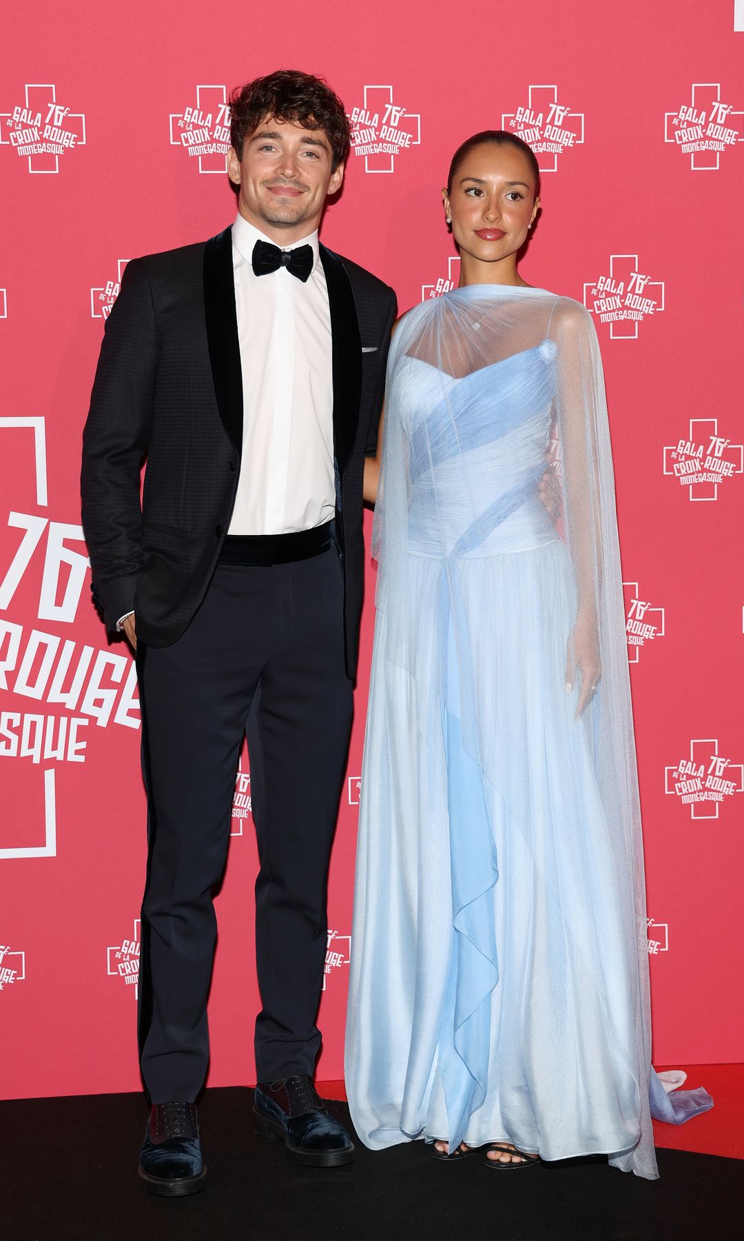 Charles Leclerc in a black tuxedo and Alexandra Saint Mleux in a sheer dress