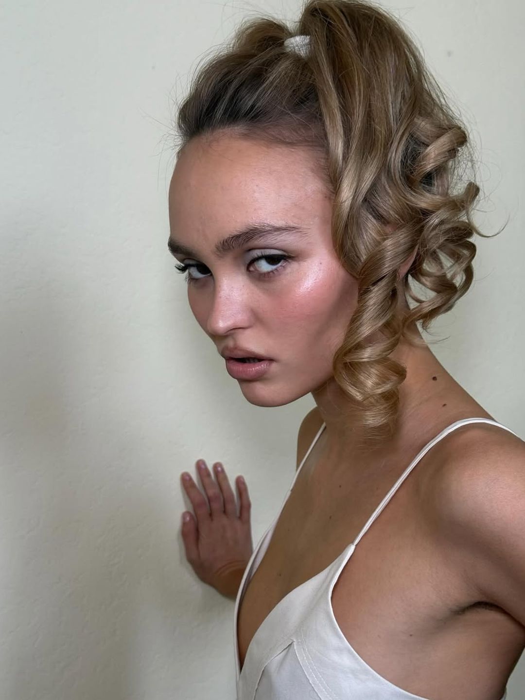 Lily-Rose Depp with slick updo and ringlet curls 