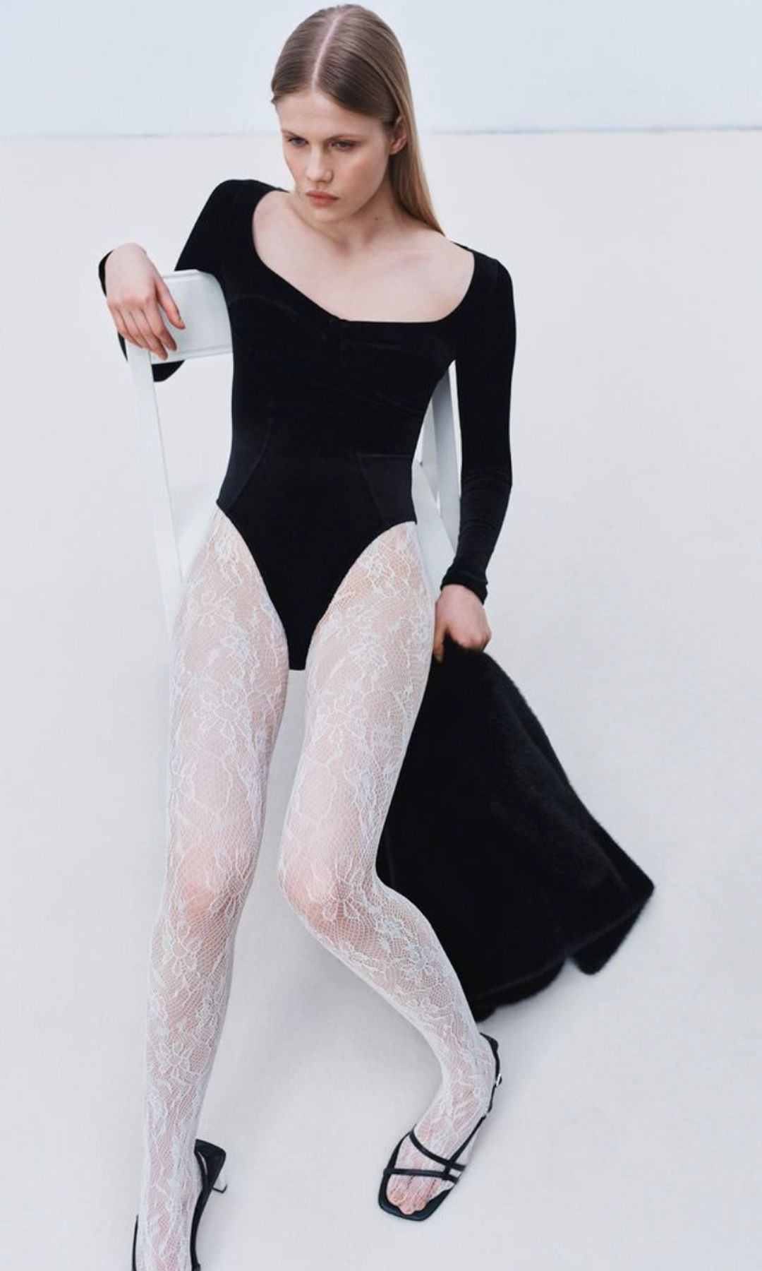 model in white lace tights and bodysuit