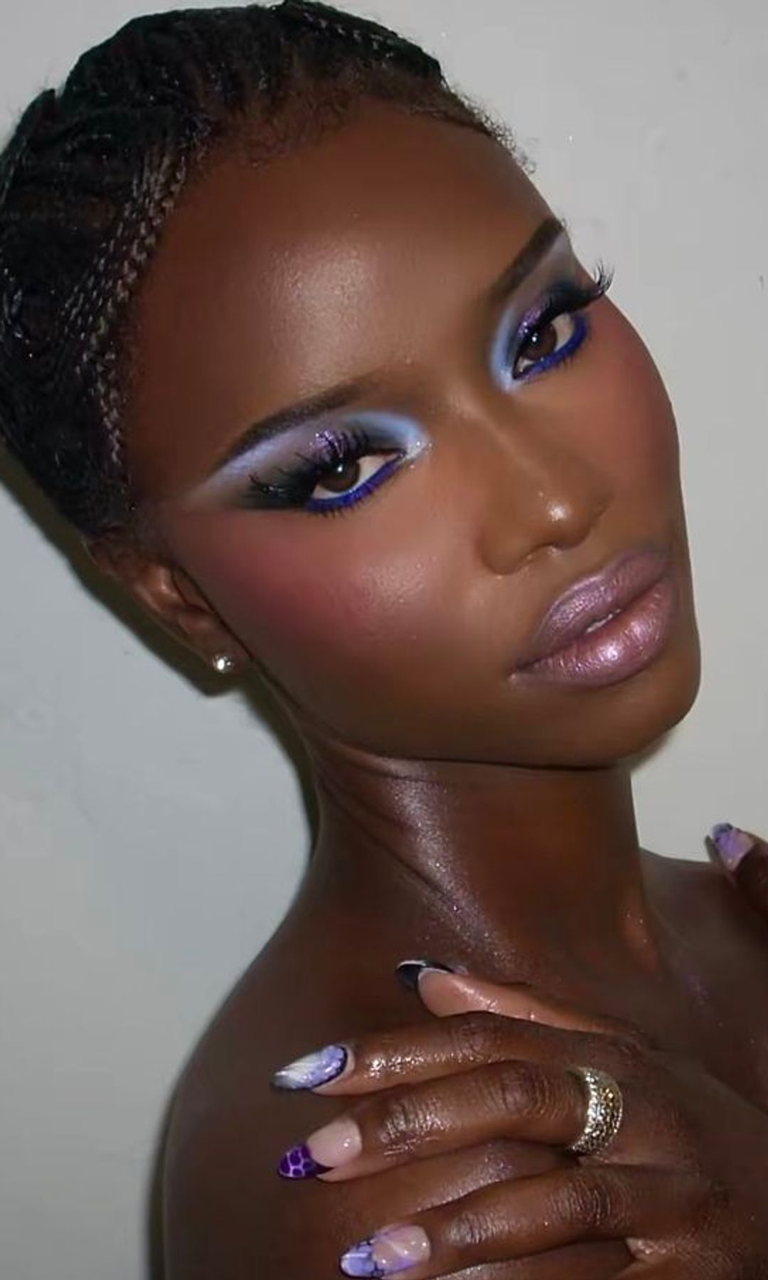 a woman with bright blue eyeshadow