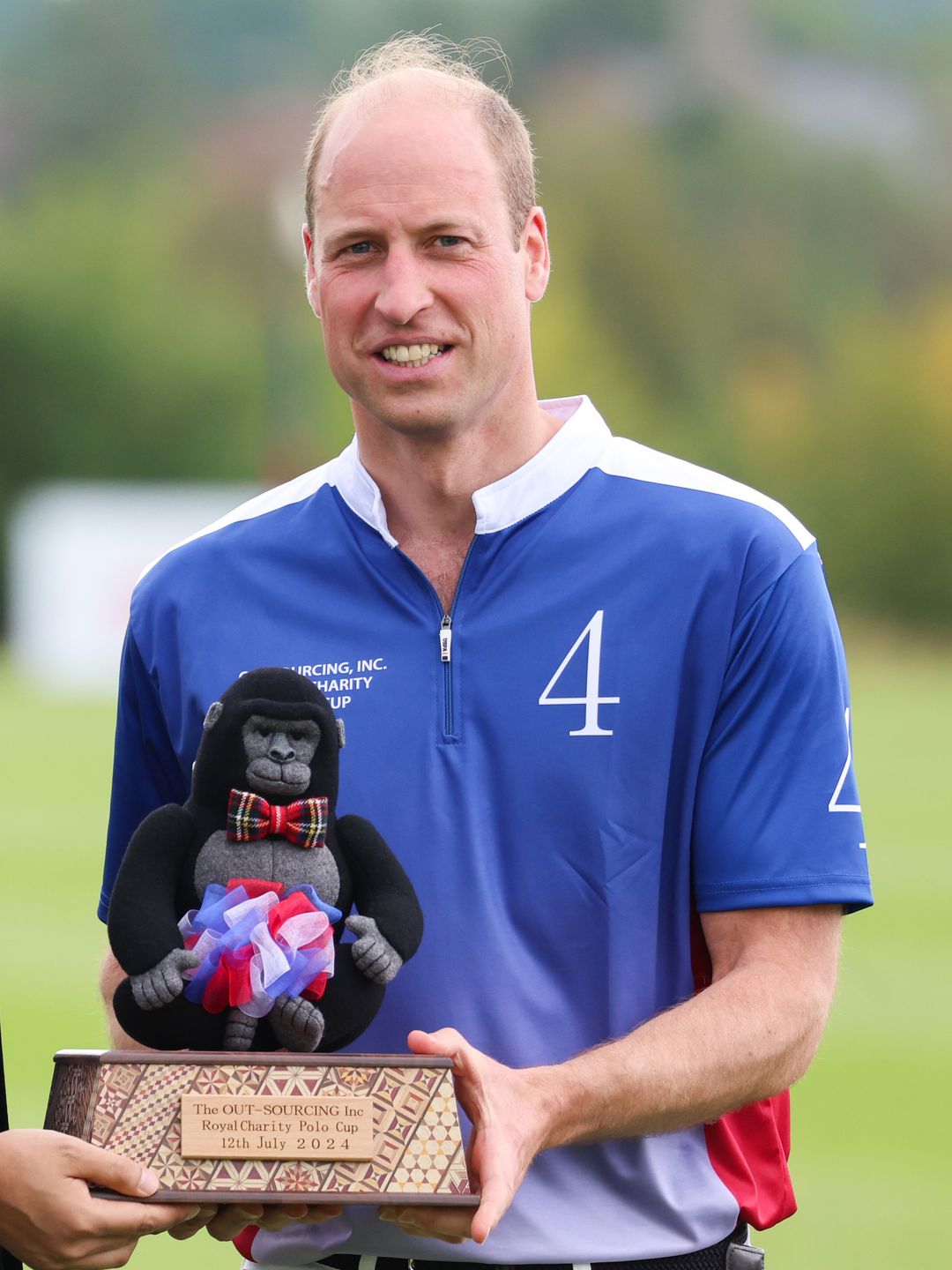 Prince William holding a gorilla trophy