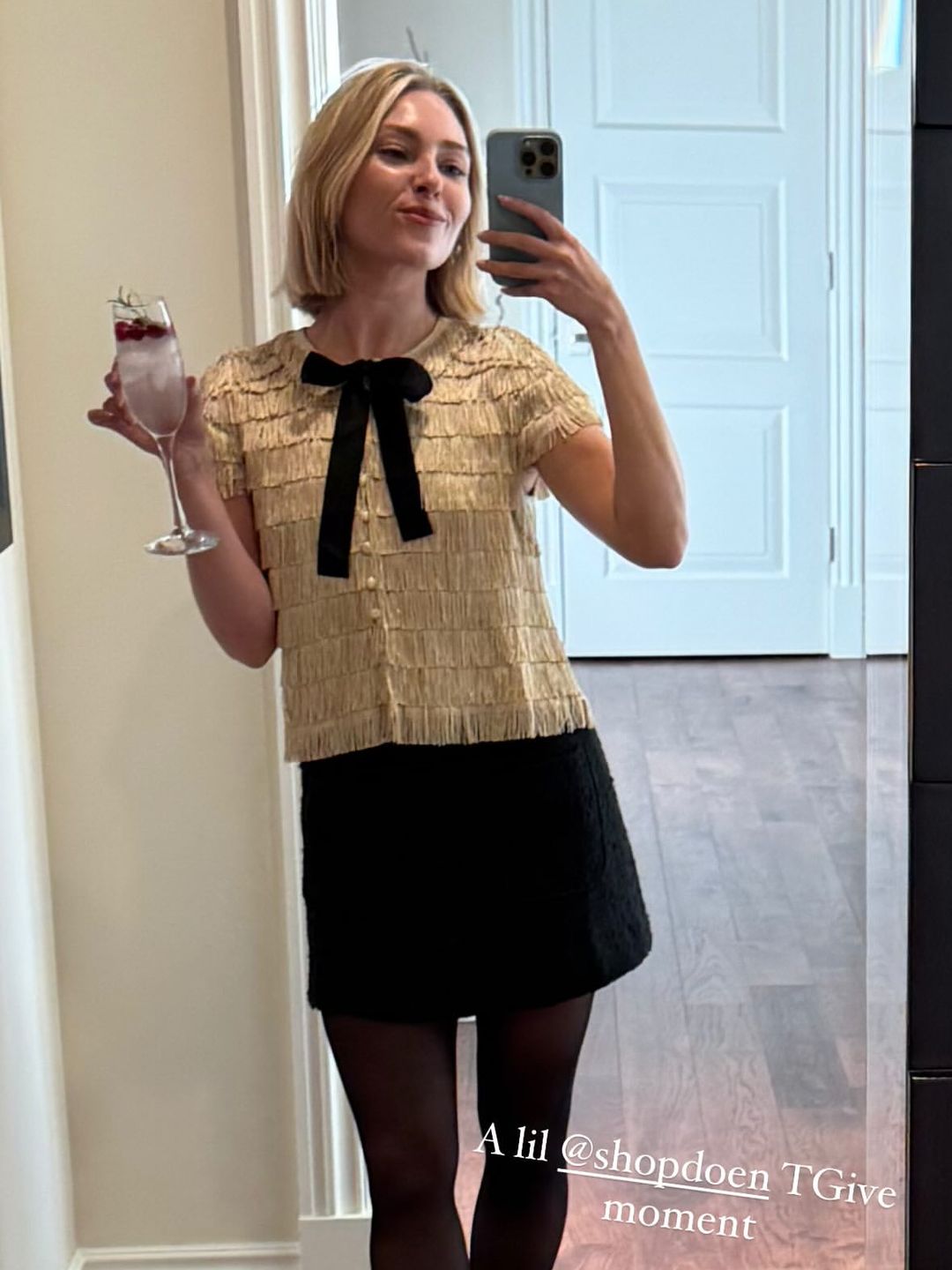 AnnaSophia Robb shares a mirror selfie in a black skirt, tights and bow blouse