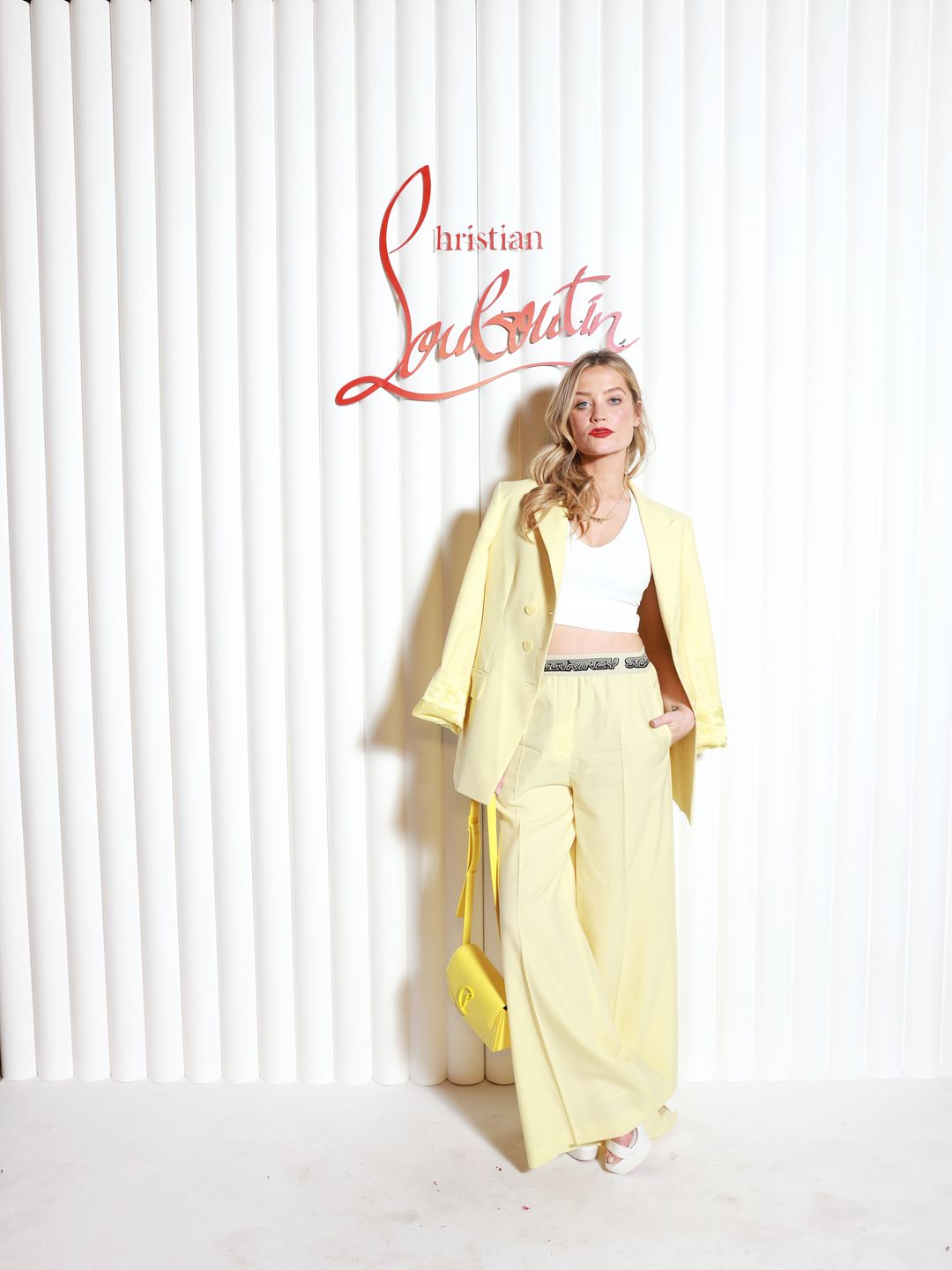 Laura Whitmore attends "The Loubi Show" as part of Paris Fashion Week in a yellow suit