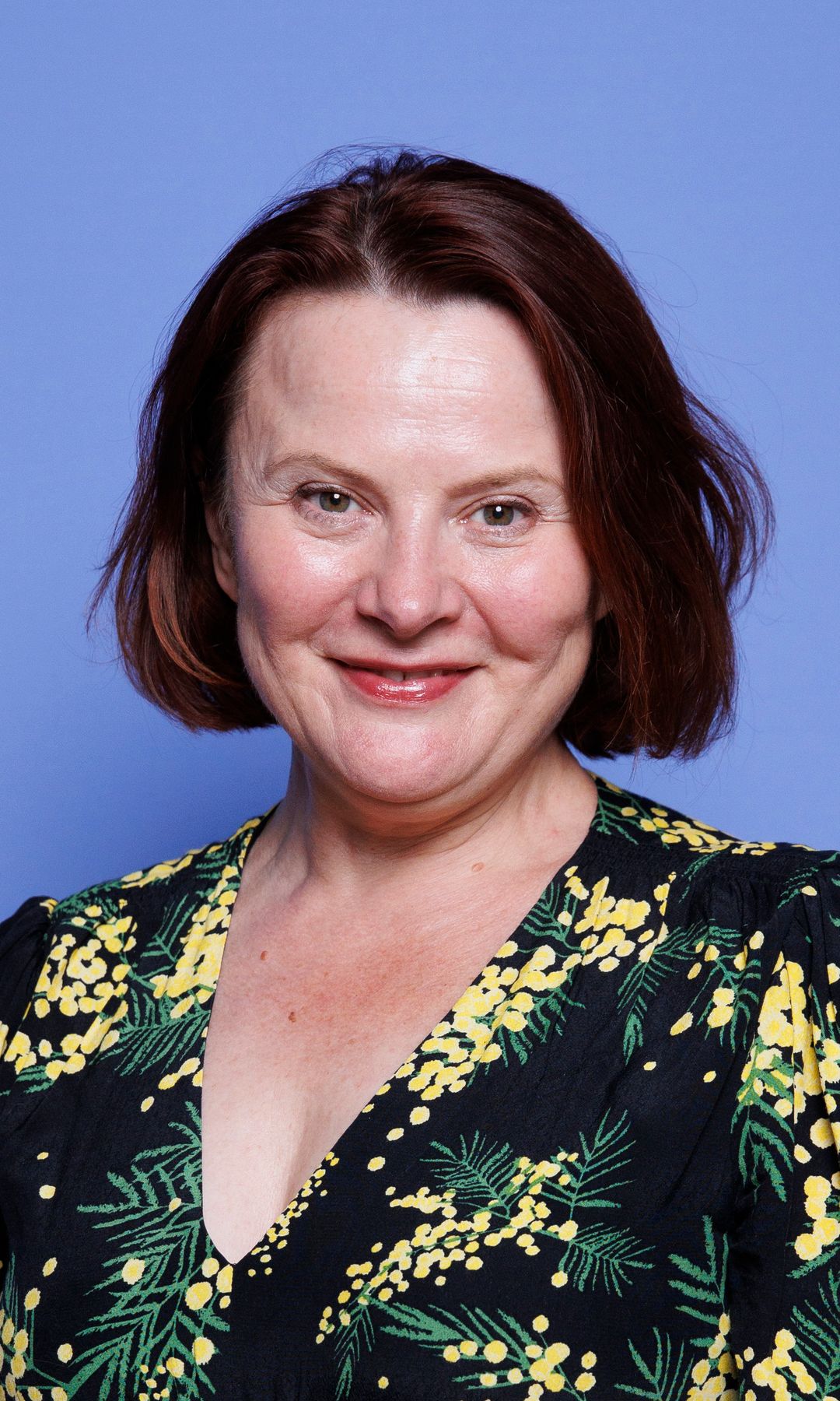 Monica Dolan in a floral outfit