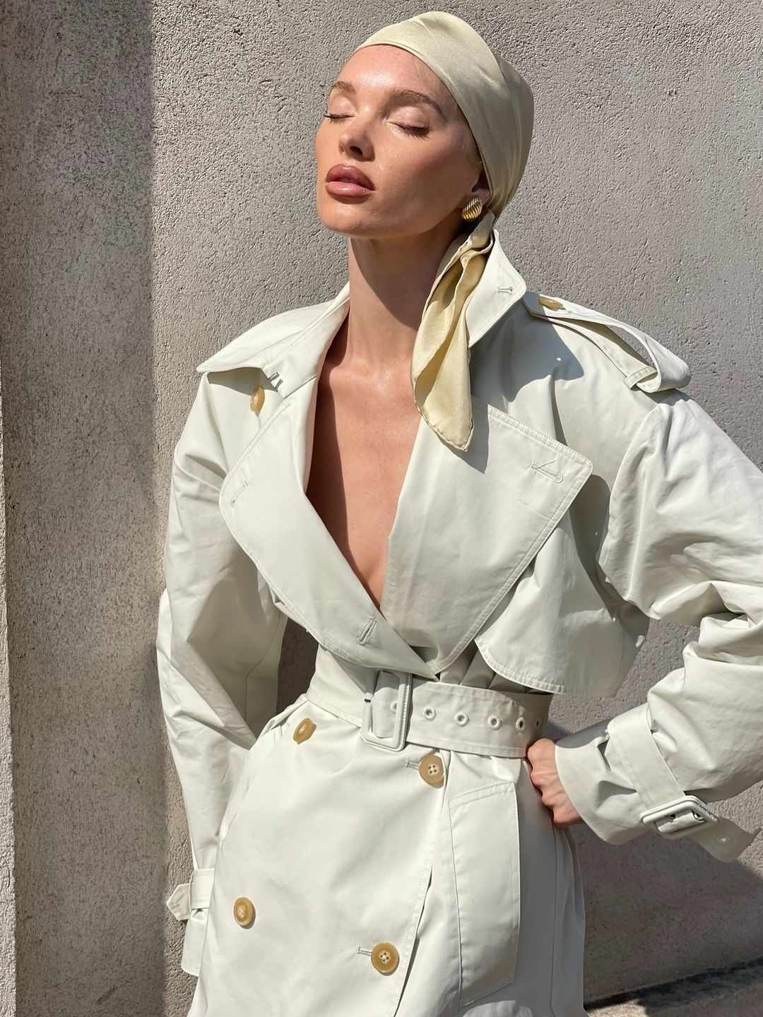 Elsa Hosk poses in a trench coat with nothing underneath