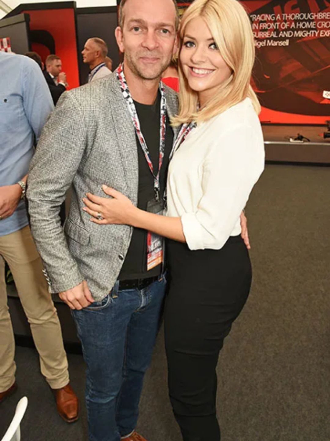 Holly Willoughby in a white shirt hugging her husband Dan