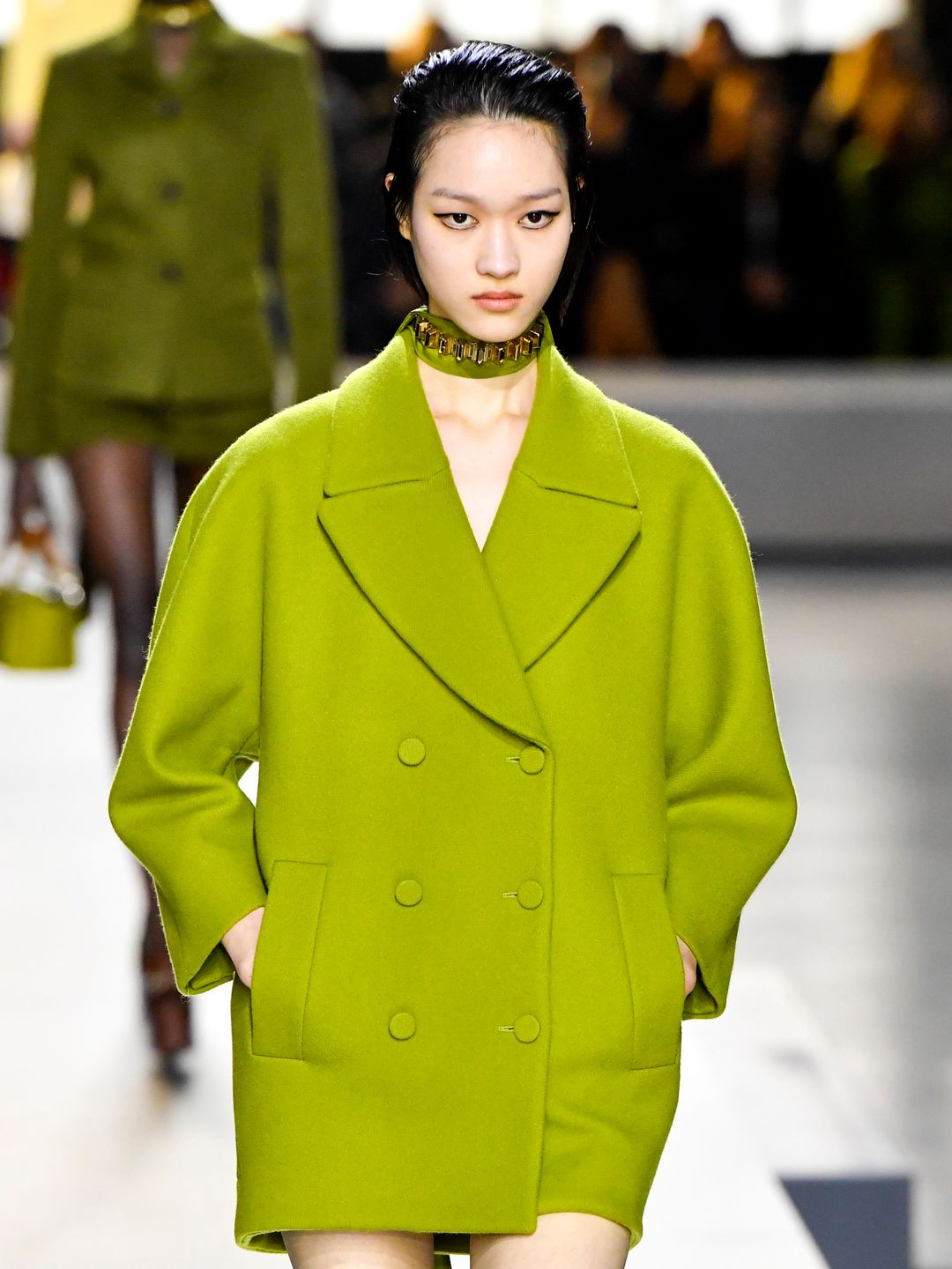 A model walks the runway during the Gucci Ready to Wear Fall/Winter 2024-2025 fashion show in a lime green coat