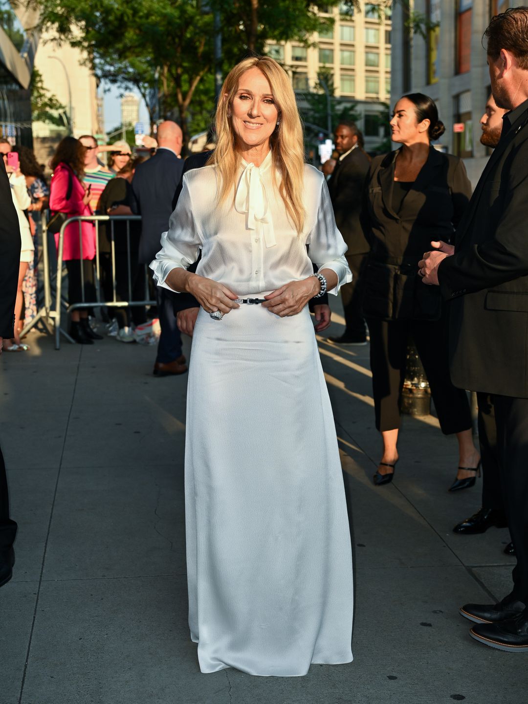 Celine Dion arrives at the "I Am: Celine Dion" screening at Alice Tully Hall on June 17, 2024 in New York City wearing a white silk skirt and blouse