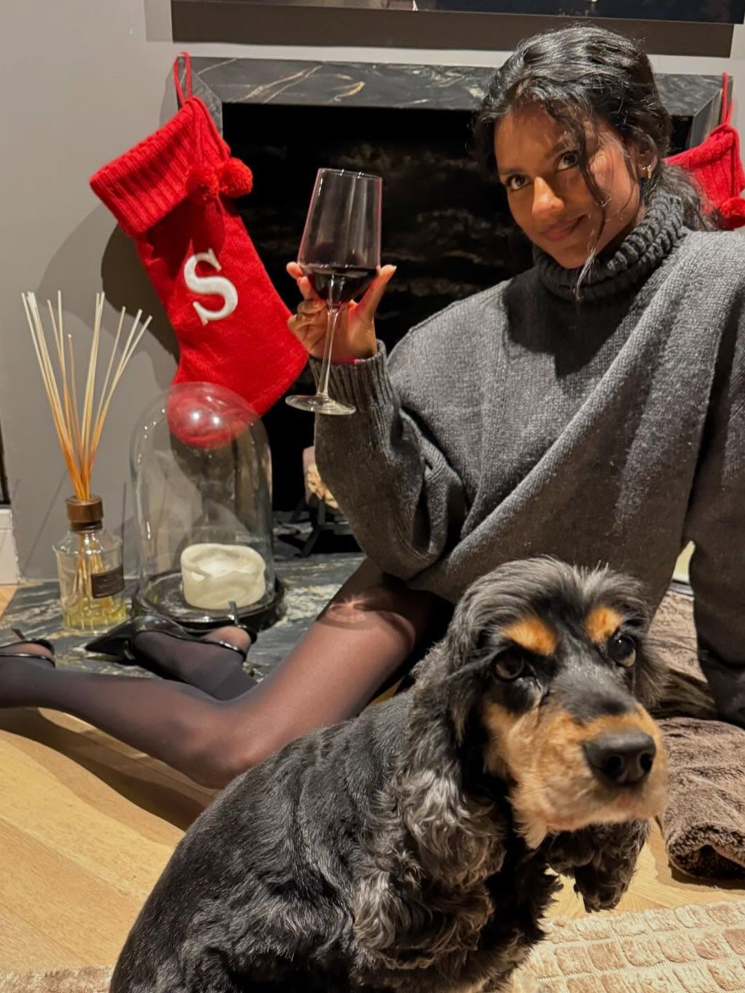 Simone Ashley poses in tights and a knitted grey jumper on her Instagram