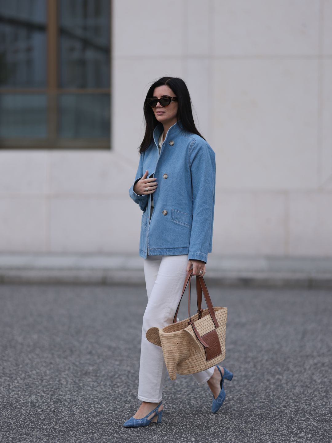 Fashion week guest wearing white jeans with a denim jacket 