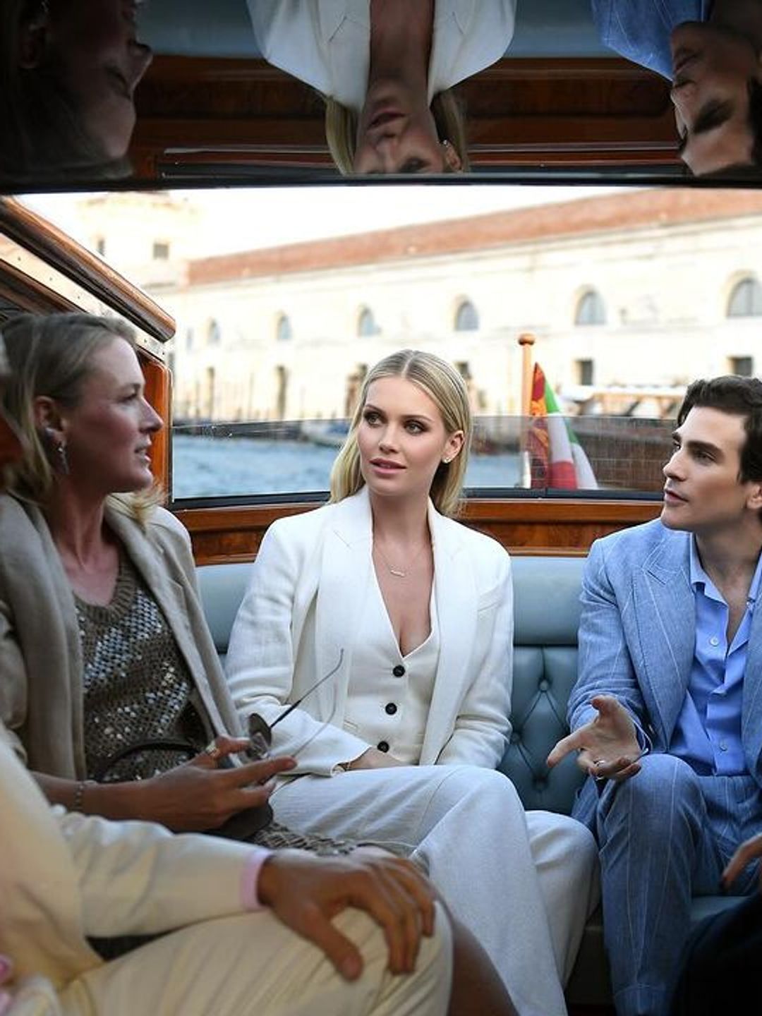 Lady Kitty Spencer in the back of speedboat with friends on the canals of Venice