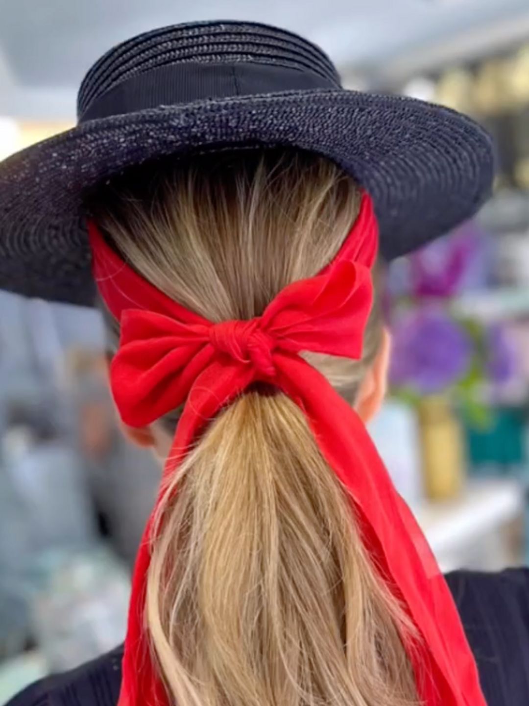 Hair in a red bow ponytail with a hat 
