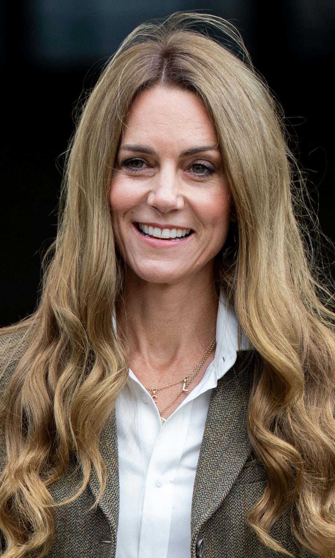 Kate Middleton smiling with bouncy blonde hair