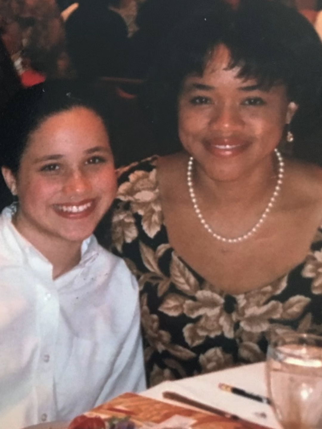 A young Meghan Markle and Doria Ragland at a dinner