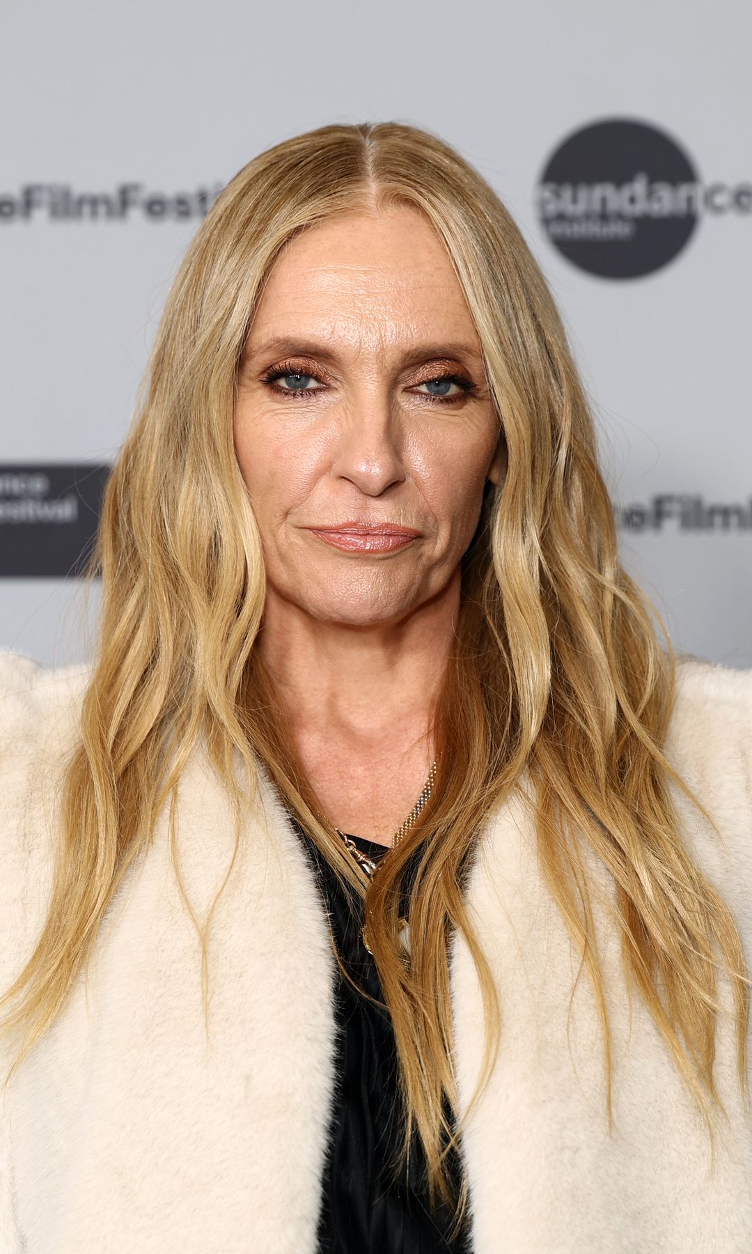 Toni Collette wearing a white fur coat