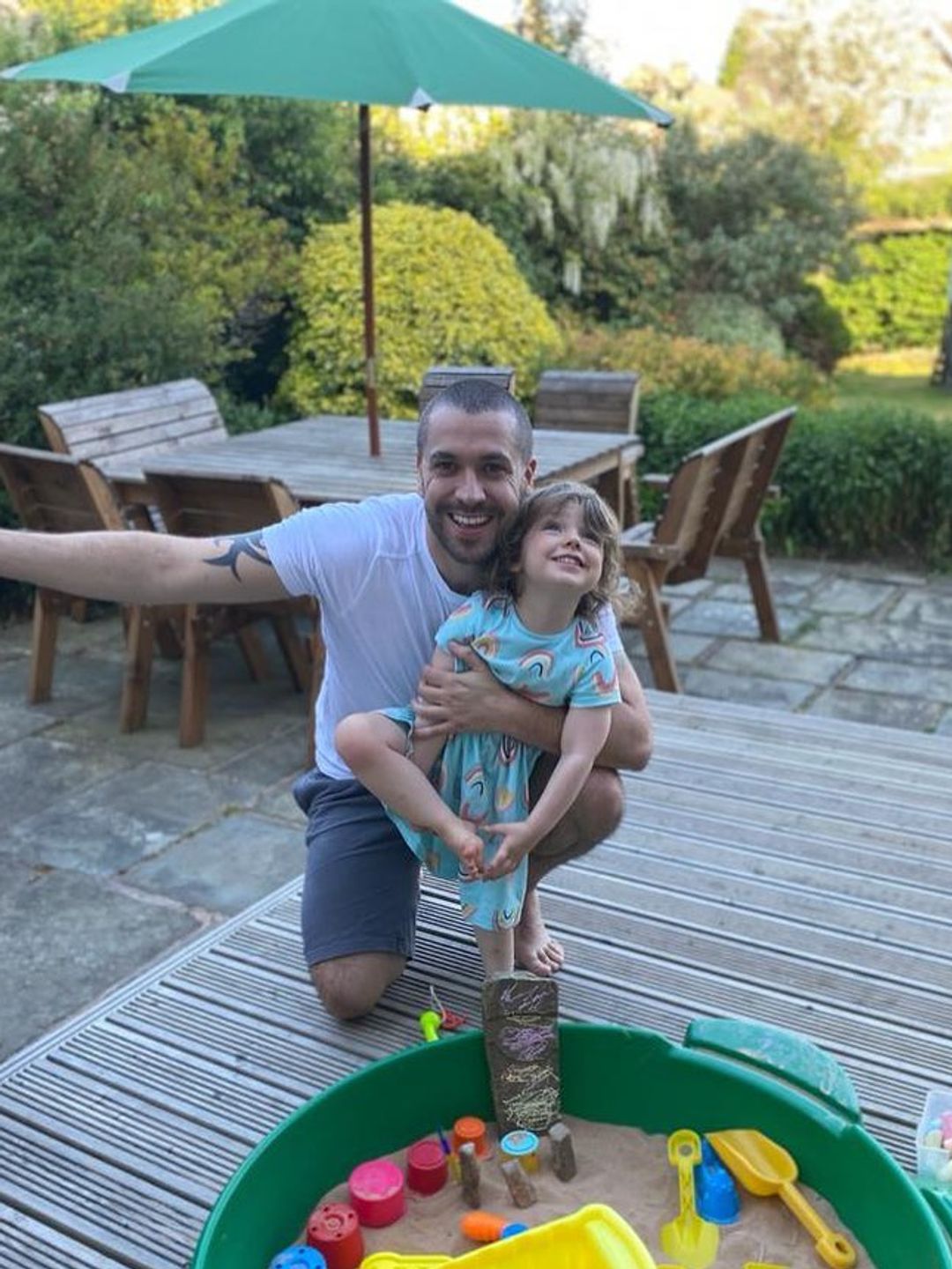 father posing in garden with daughter