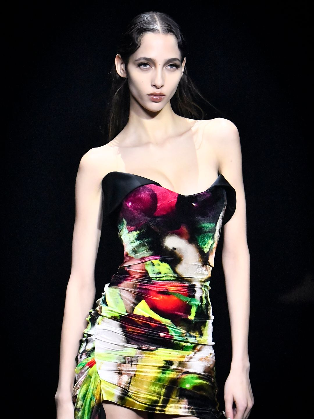 A model walks the runway during the Mugler Ready to Wear Fall/Winter 2024-2025 fashion show in a printed mini dress