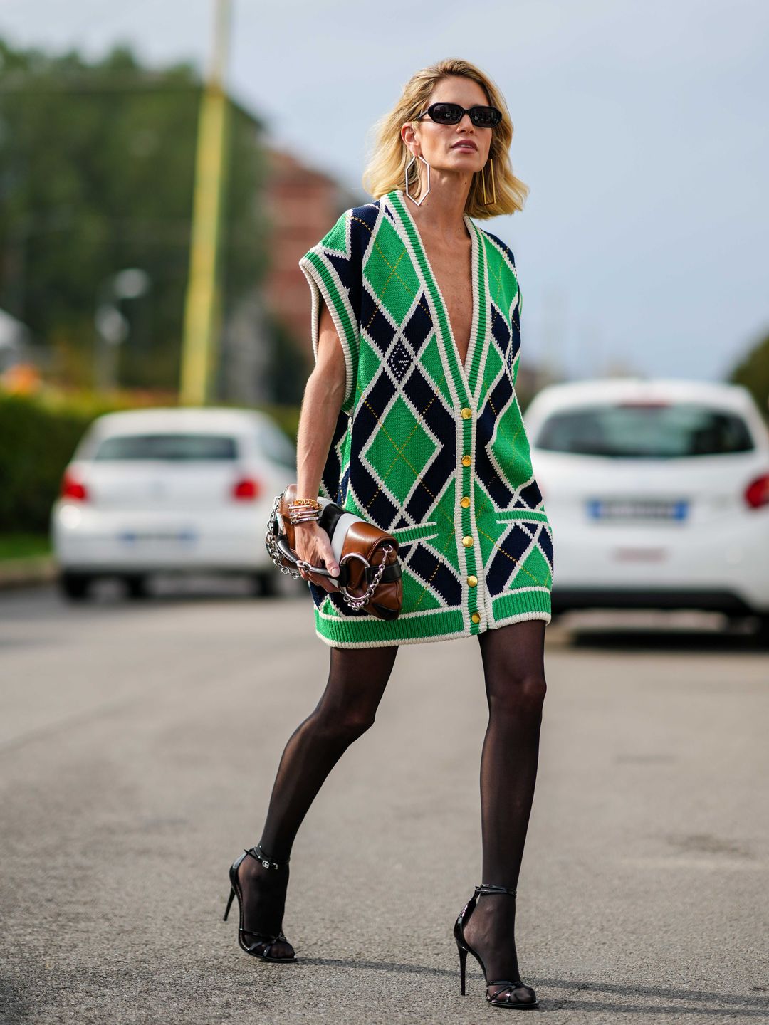 Helena Bordon rocks a mini dress-length waistcoat with sheer tights and minimalist heels 