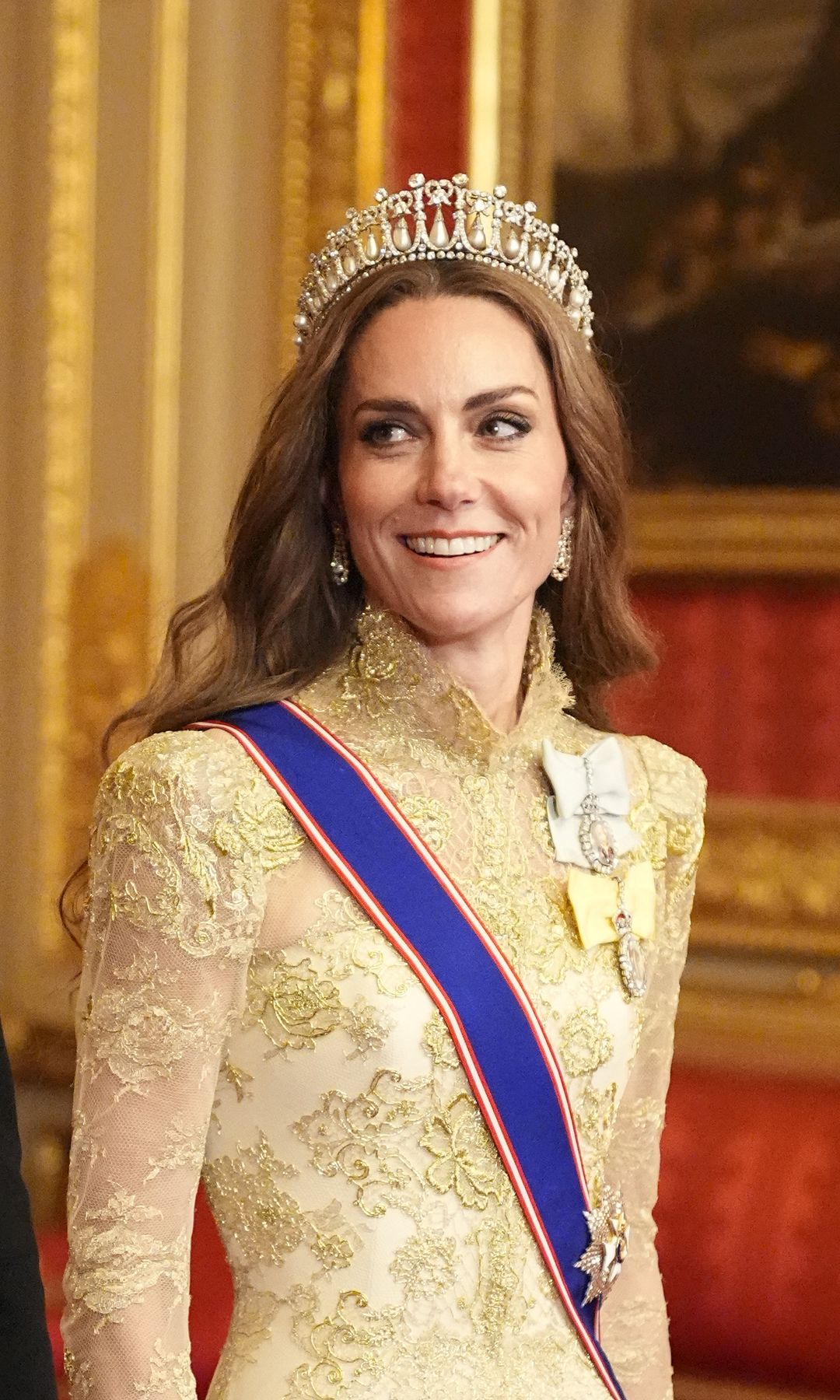 Kate Middleton in a gold dress and tiara