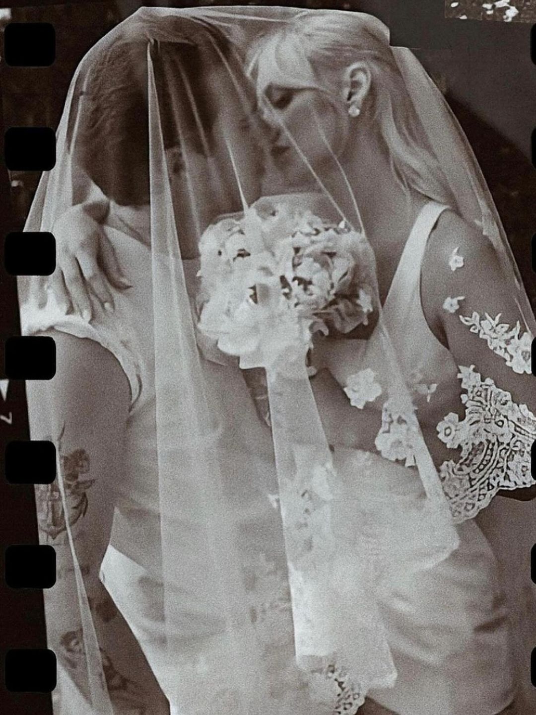 Nicola and Brooklyn Peltz-Beckham share a kiss under a veil
