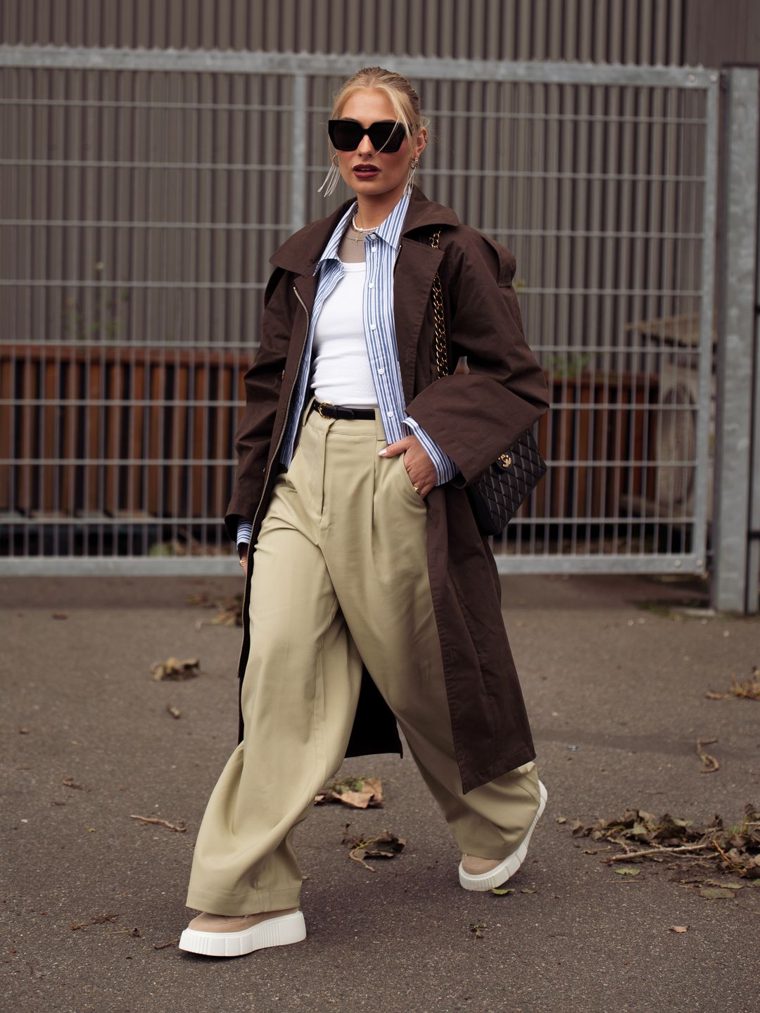 Woman wearing a trench coat with wide-leg trousers 