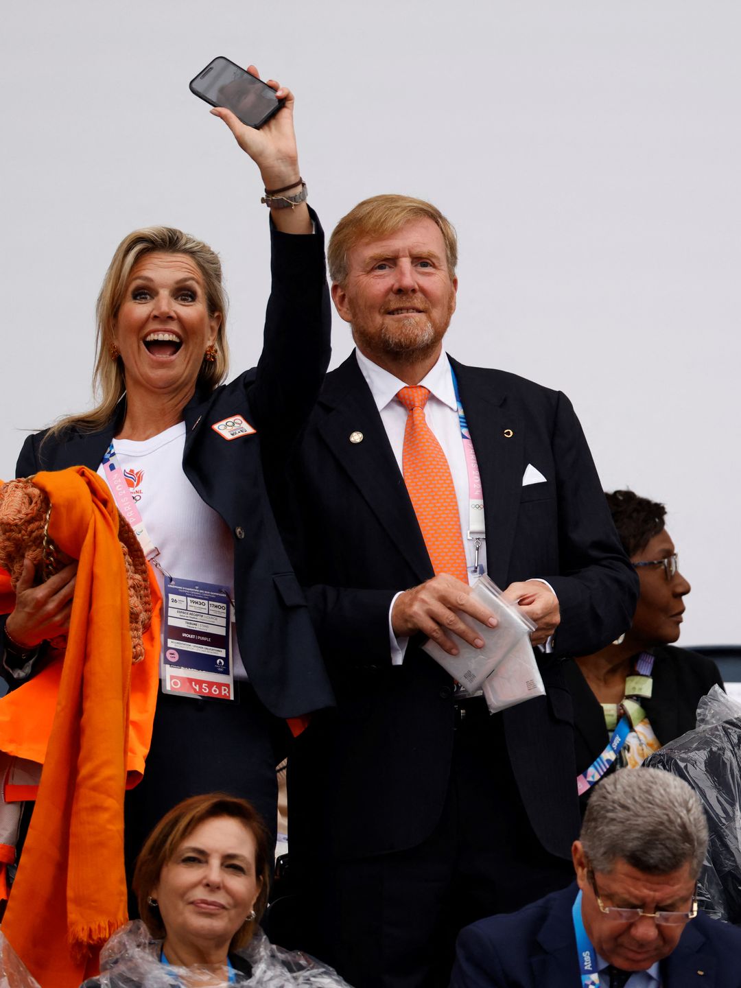 King Willem-Alexander of the Netherlands (CR) and Queen Maxima of the Netherlands wave ahead of the opening ceremony of the Paris 2024 Olympic Games