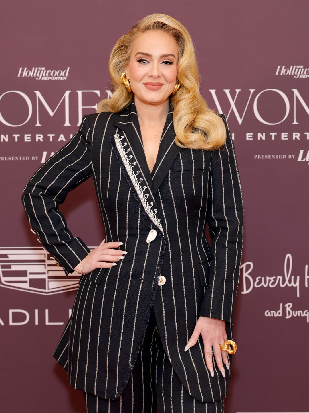 Adele on the red carpet in a striped suit
