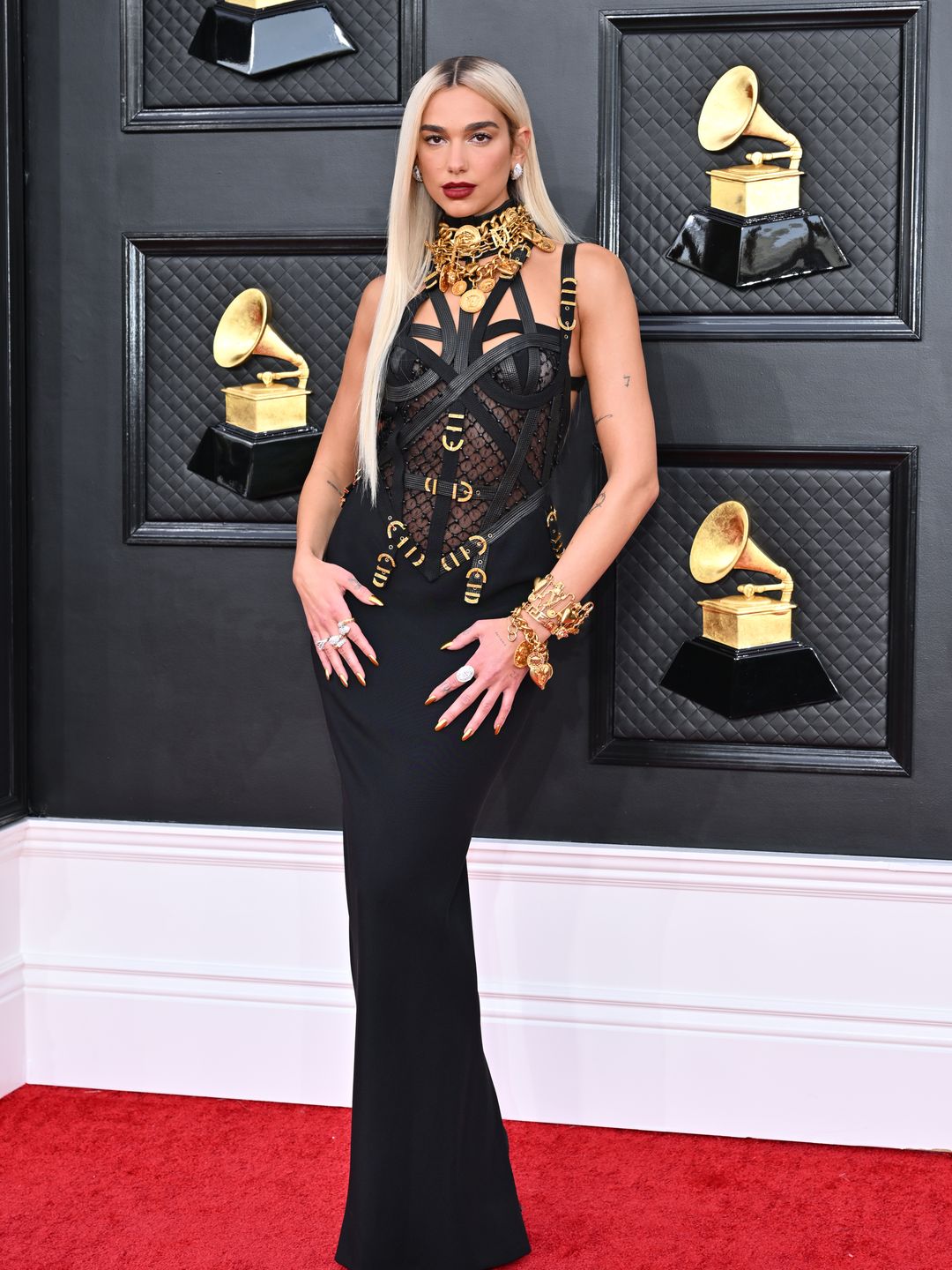 Dua Lipa at the 64th Annual Grammy Awards wearing a Versace Gown and platinum blonde hair