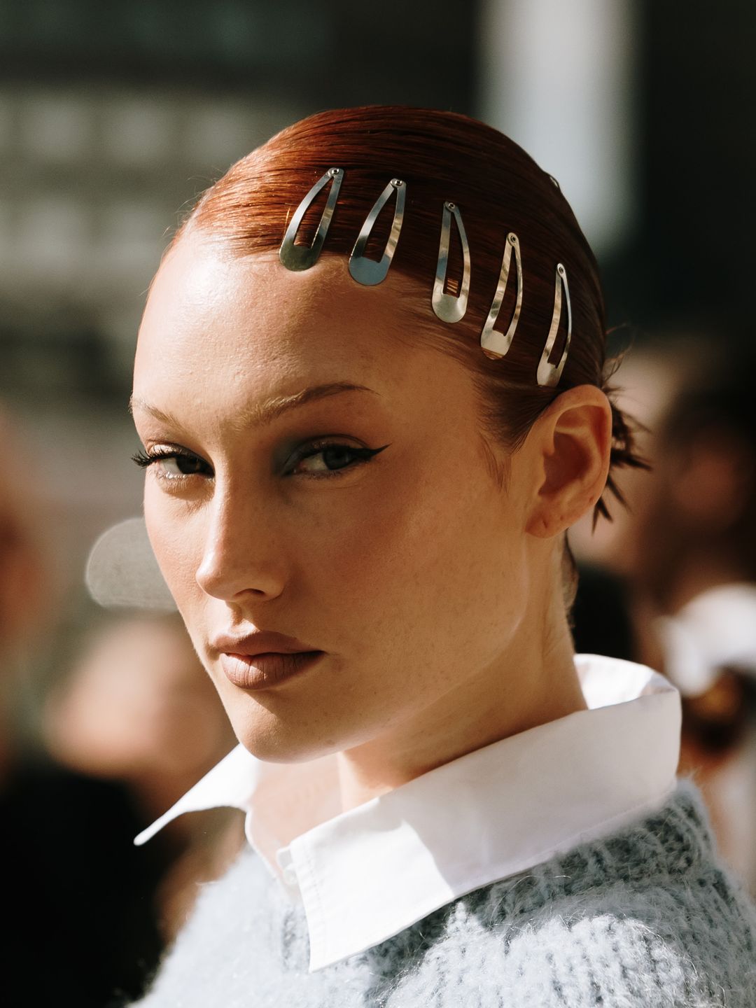 Woman at london fashion week with a row of clips in her hair 